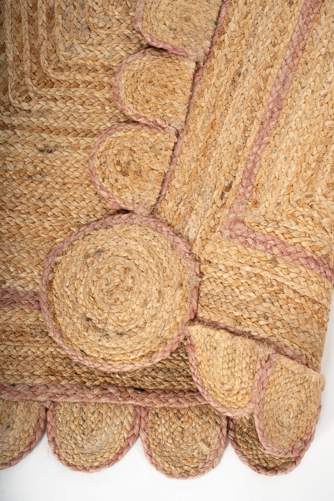 Loko scalloped jute braided area rug-Dusky Pink detail showing the textured jute surface and finishing