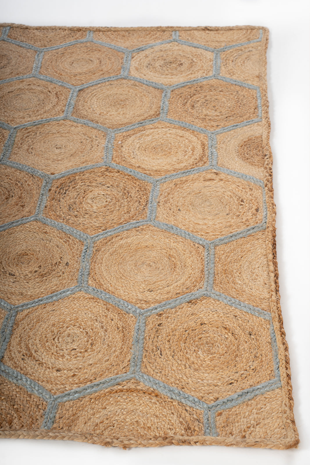 Malabo jute braided area rug jute rug styled in a living room interior