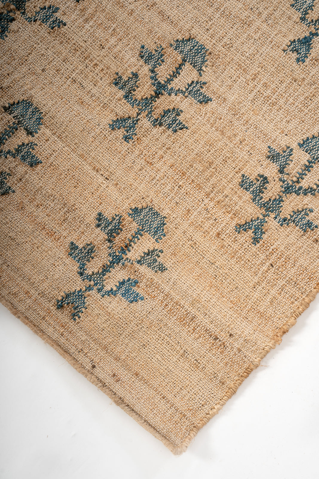 Meadow Bloom Jute Rug close-up showing the jute pile and floral motif