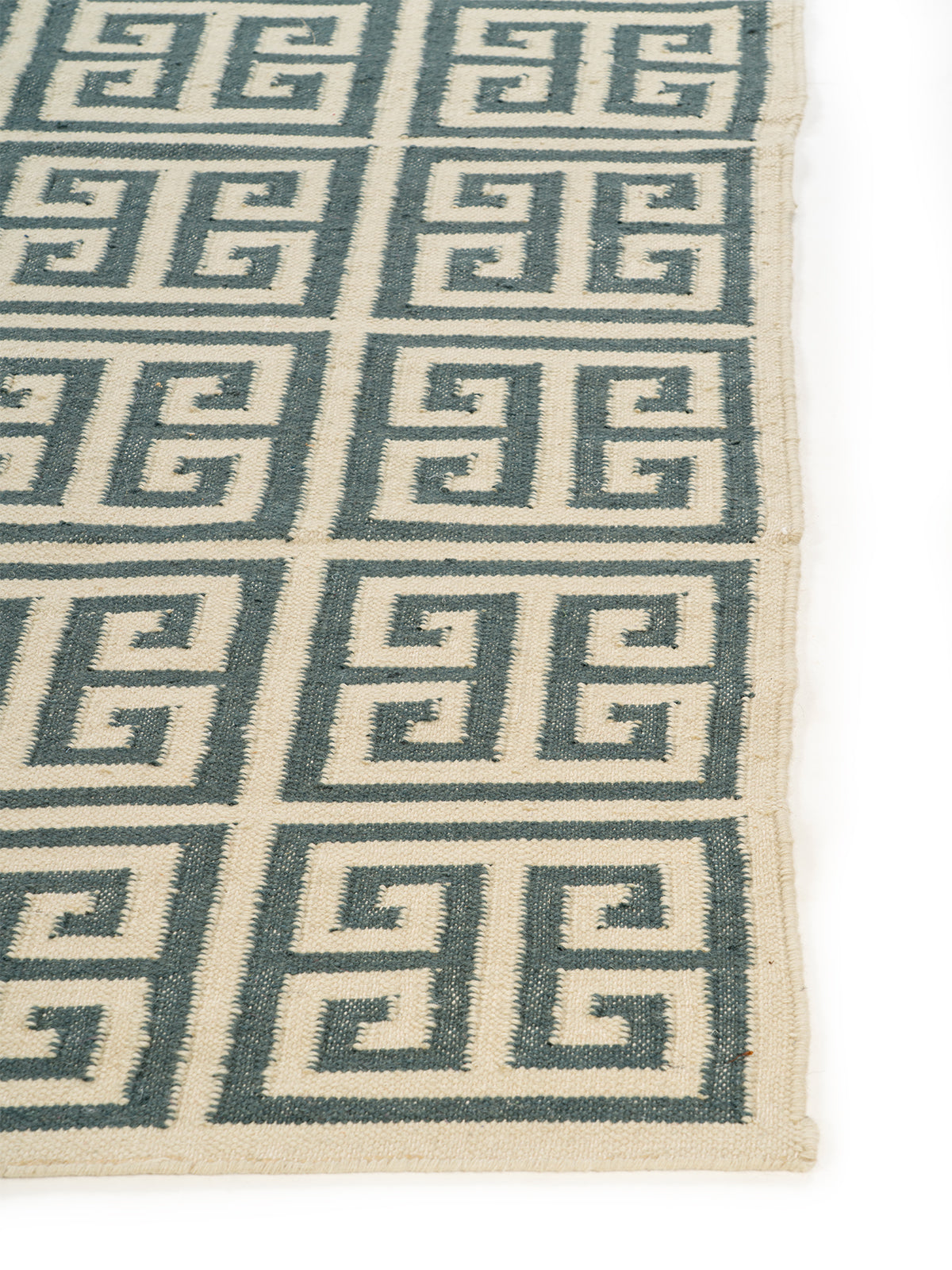 Meander Grid Wool Rug wool rug styled in a living room interior