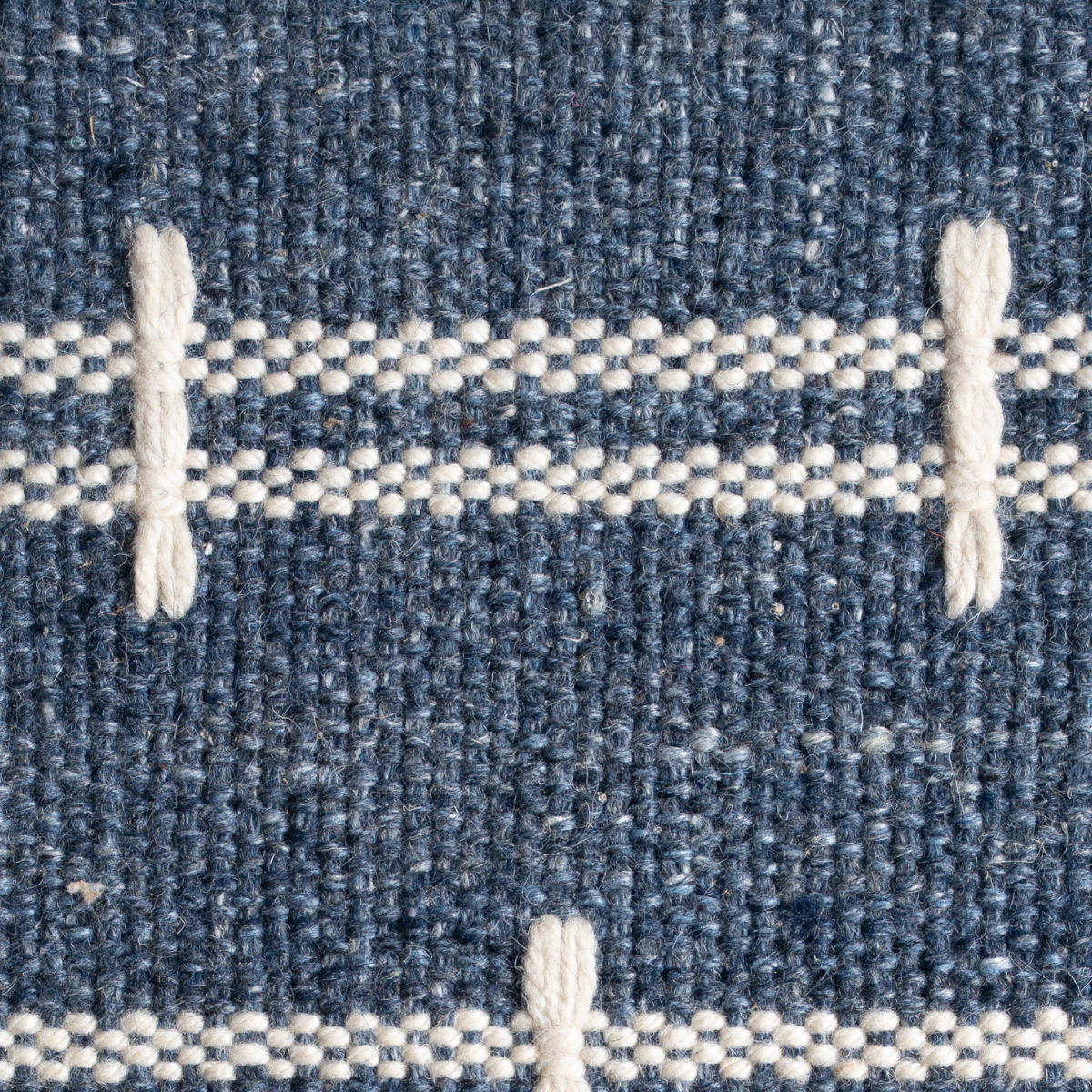 Meridian Loom : Abyss Blue close-up showing the wool weave and geometric motif