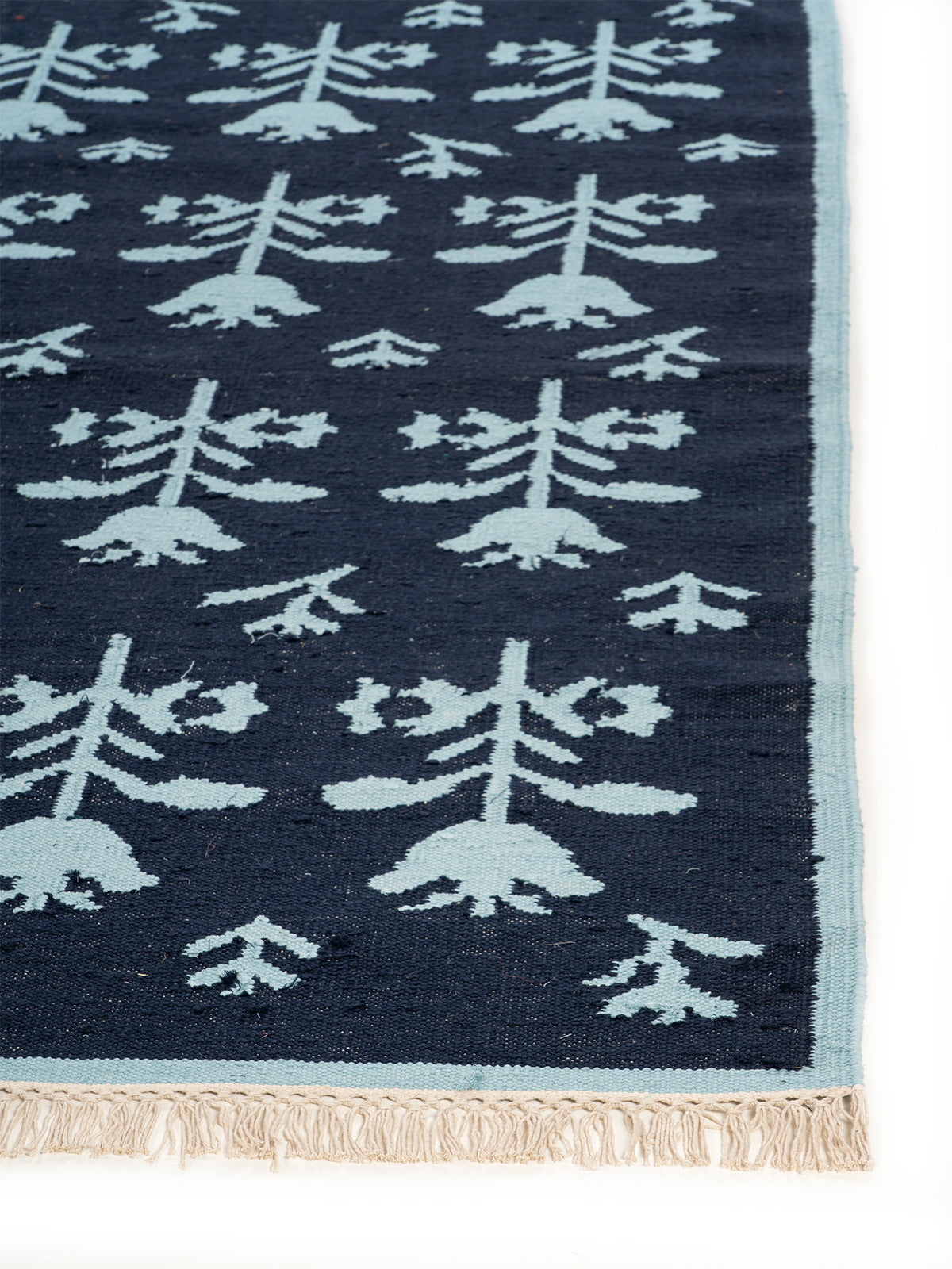 Midnight Tulip Flatweave Rug wool rug styled in a living room interior