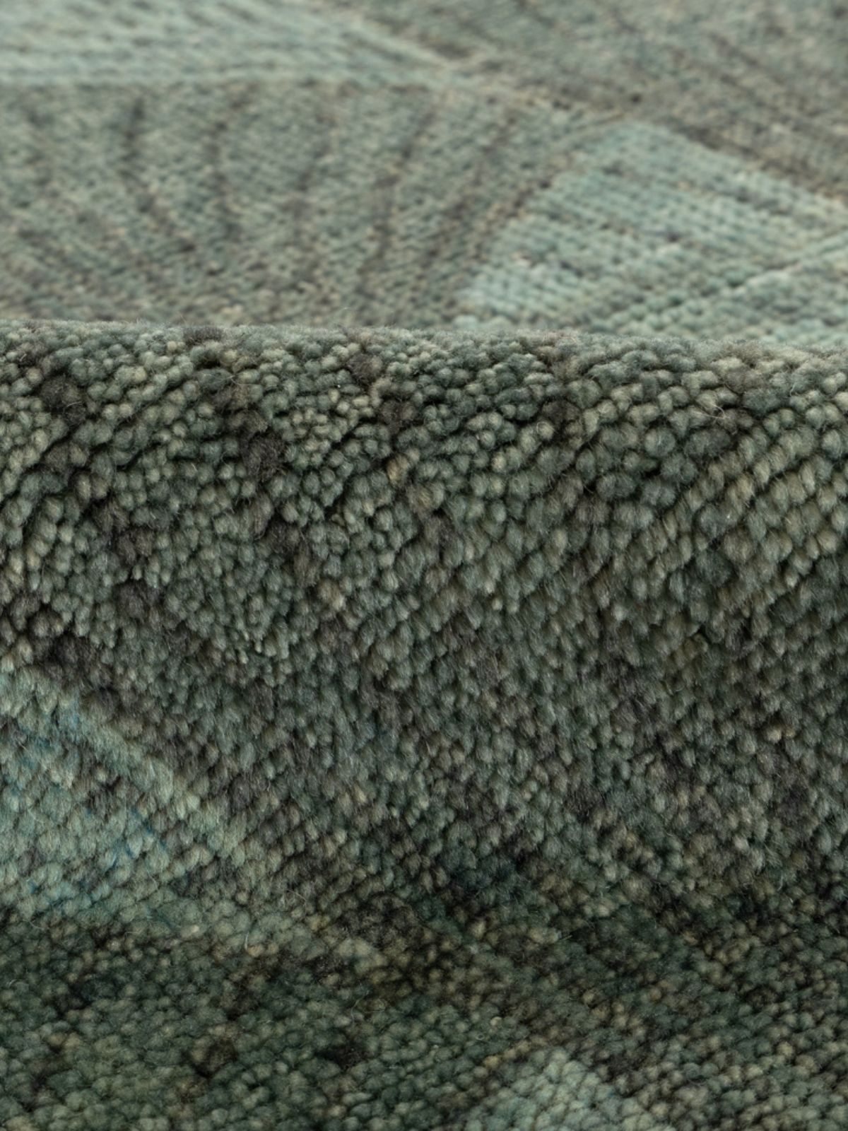 Misty harbor handknotted rug detail showing the textured wool surface and finishing