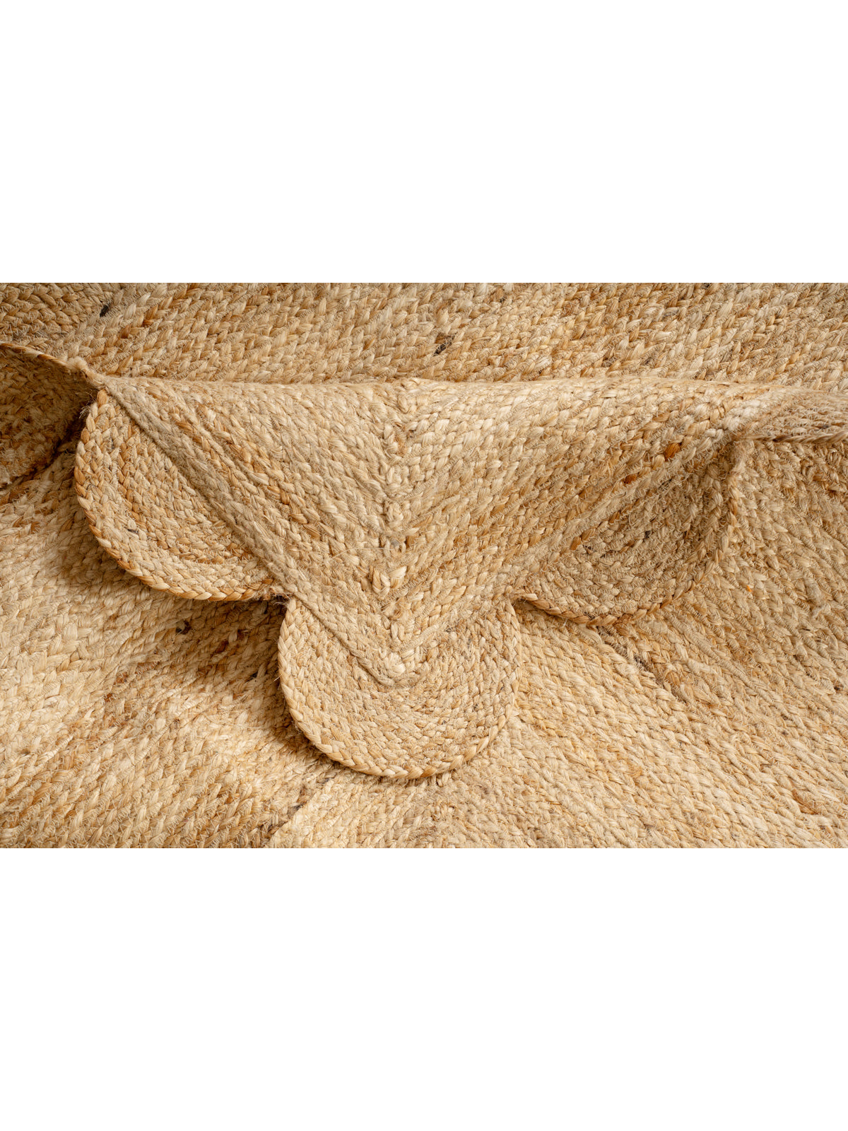 Mwanza scalloped jute rug- natural detail showing the textured jute surface and finishing