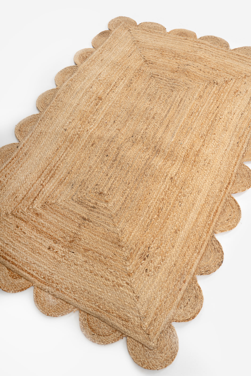Mwanza scalloped jute rug- natural jute rug styled in a living room interior