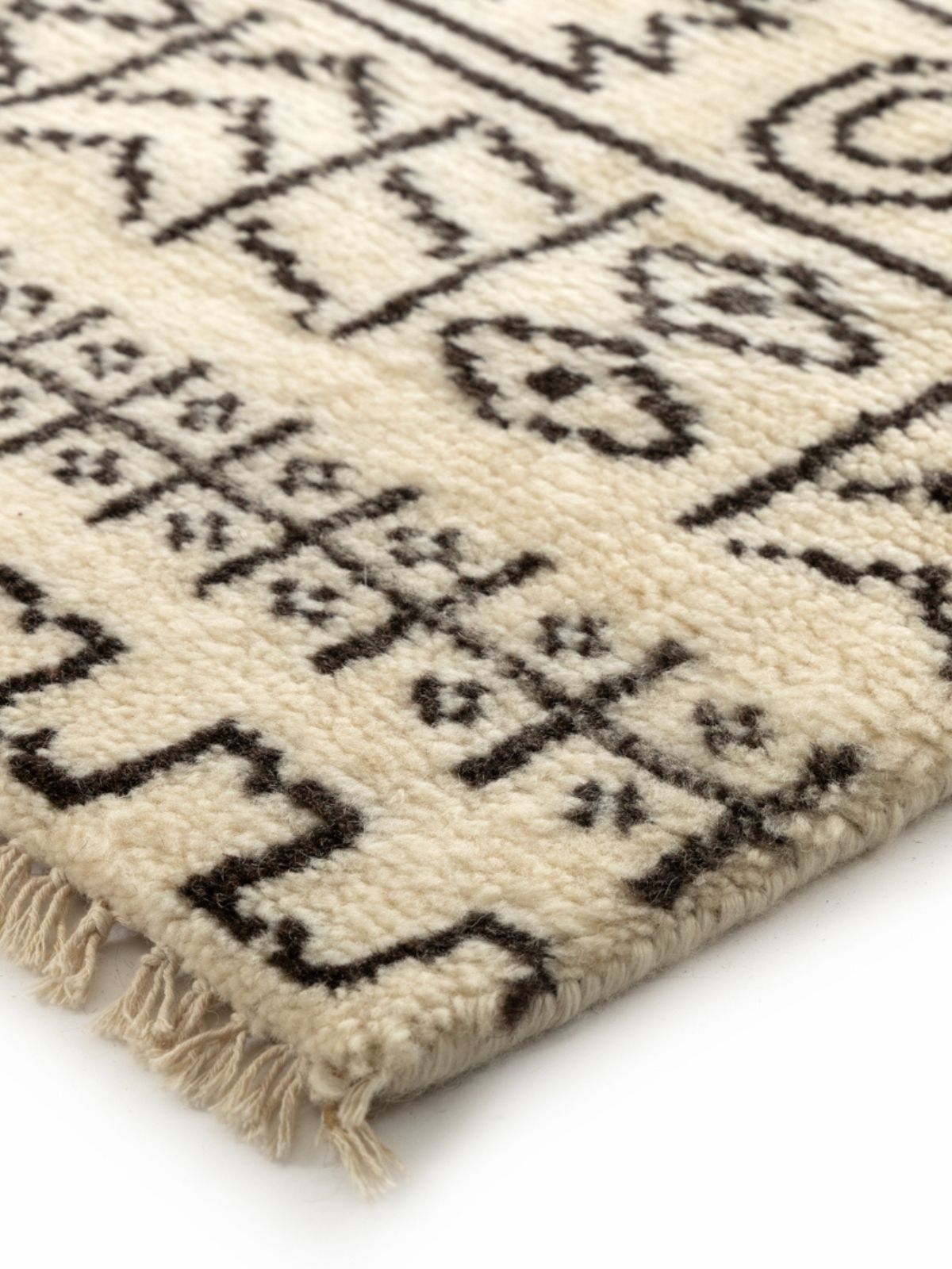 Nomad Noir Hand-Knotted Tribal Rug close-up showing the wool weave and traditional motif