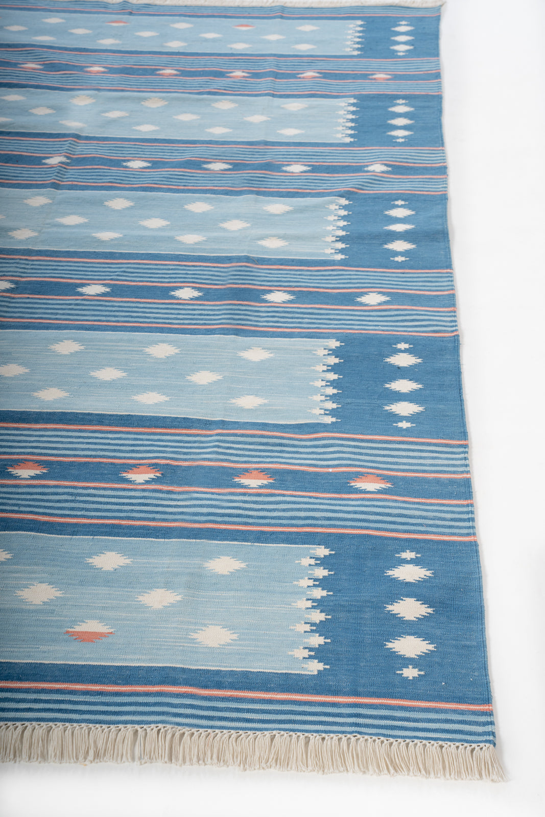 Ocean Essence Wool Flatweave Rug wool rug styled in a living room interior
