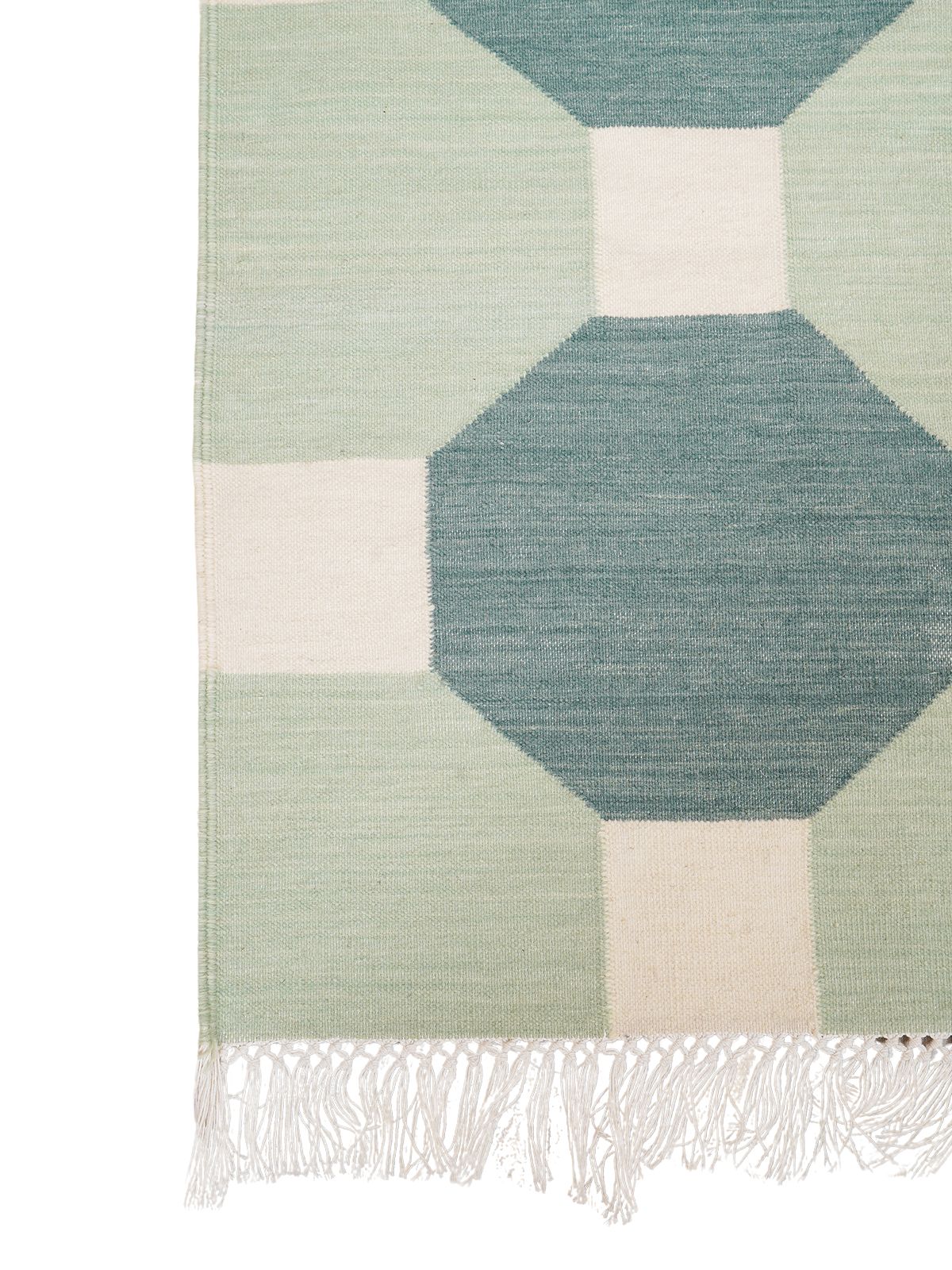 Octagonal Tapestry Wool Rug-Green wool rug styled in a living room interior
