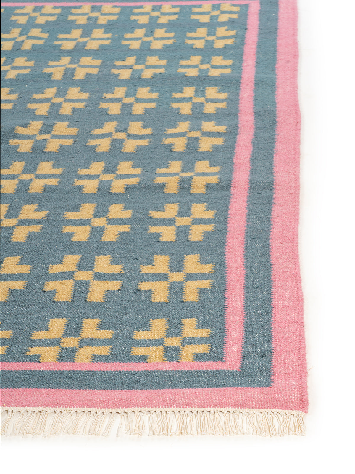 Pastel Cross Motif Flatweave Rug wool rug styled in a living room interior