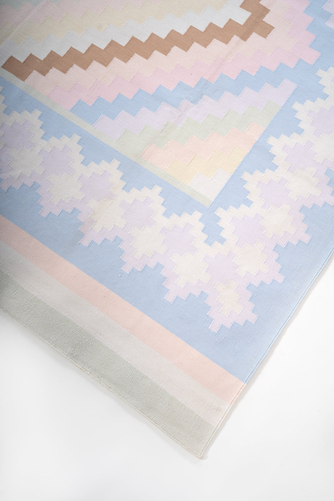 Pastel Udaipur Chevron Dhurrie close-up showing the cotton weave and geometric motif