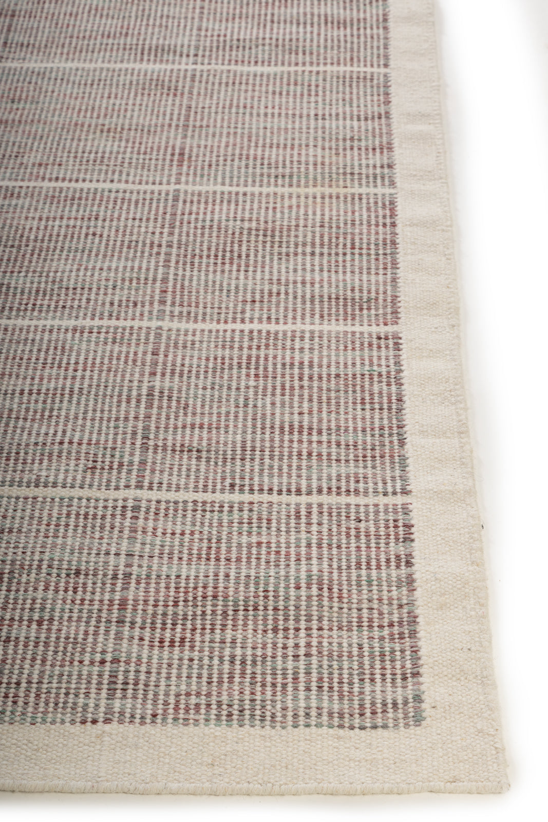 Pemberley Flatweave wool rug styled in a living room interior