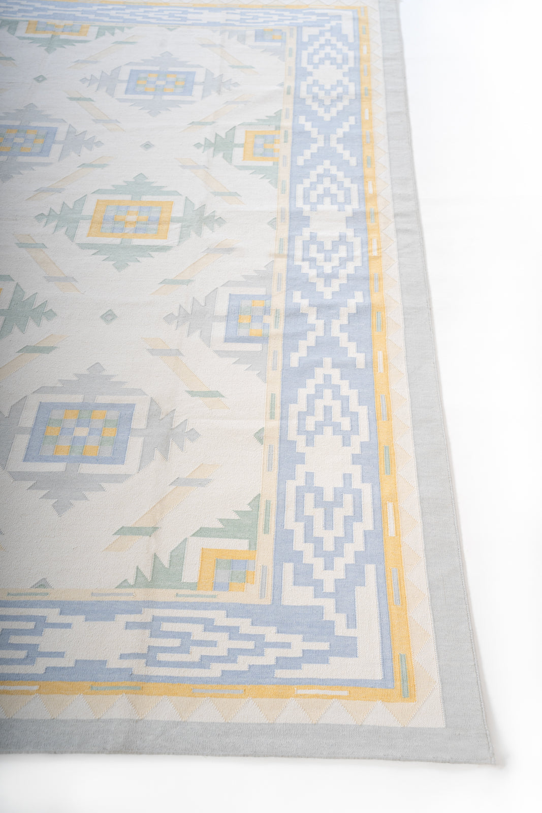 Pondicherry Tranquil Flatweave Rug cotton rug styled in a living room interior