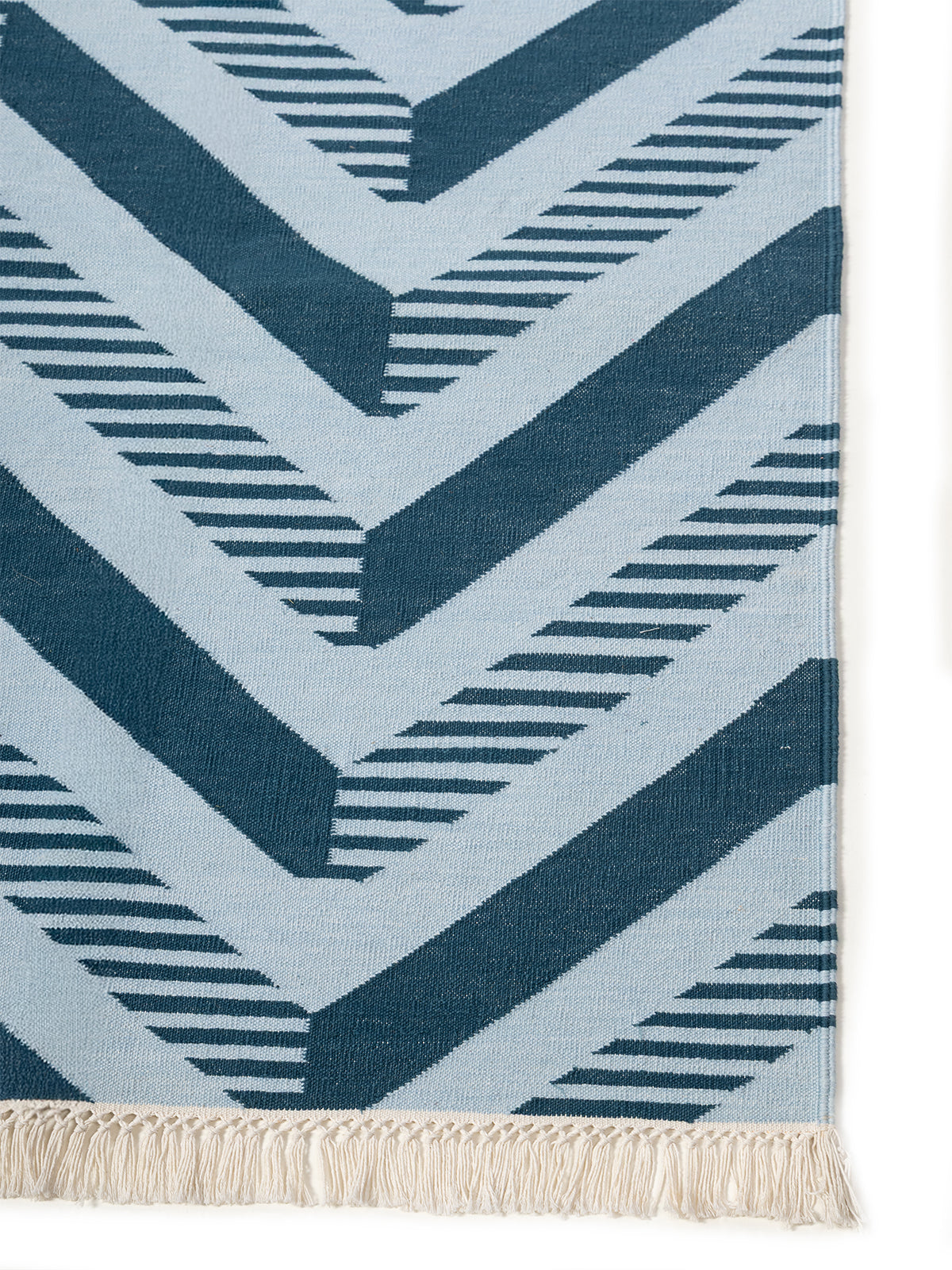Ridgeway Chevron Rug-Blue cotton rug styled in a living room interior