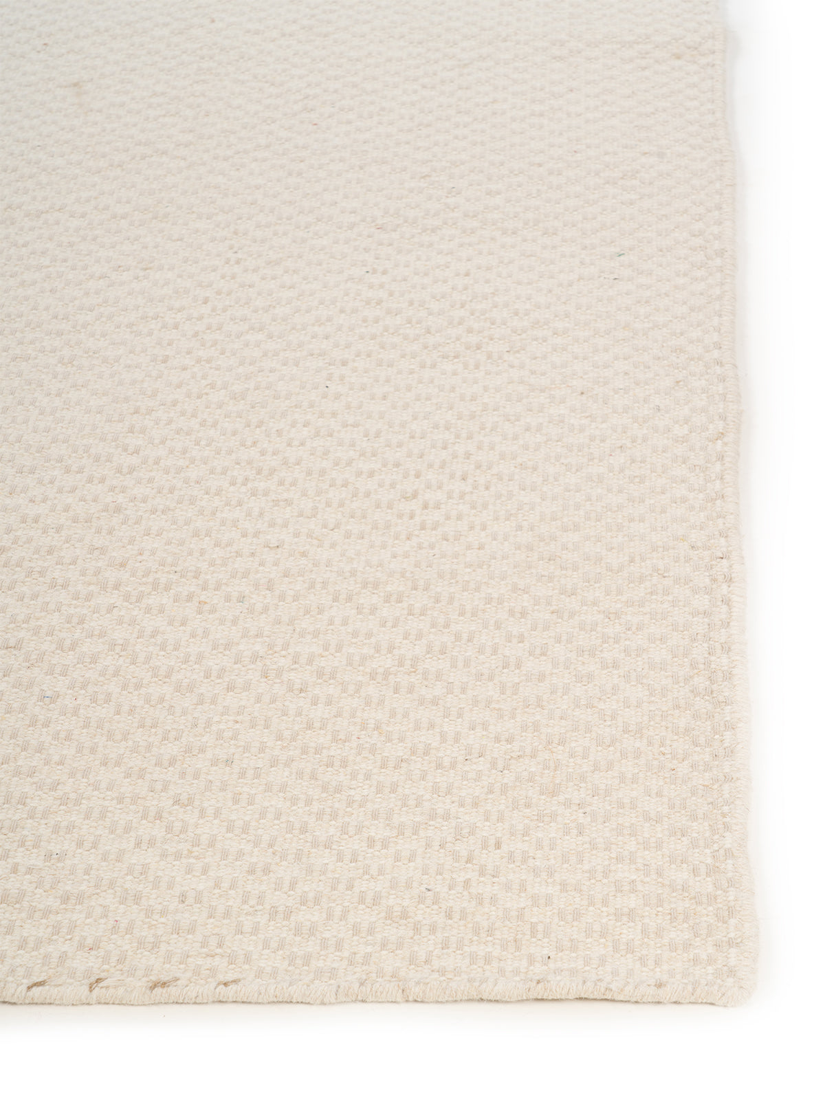 Rustic Diamond Check Wool Rug wool rug styled in a living room interior