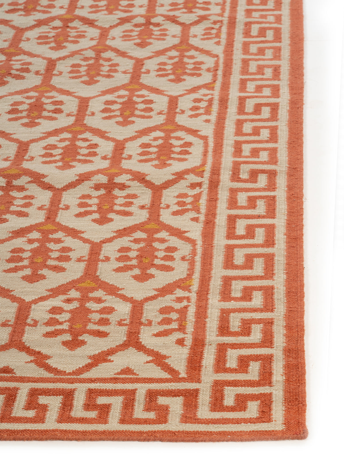 Scarlet Greek Vine Legacy wool rug styled in a living room interior