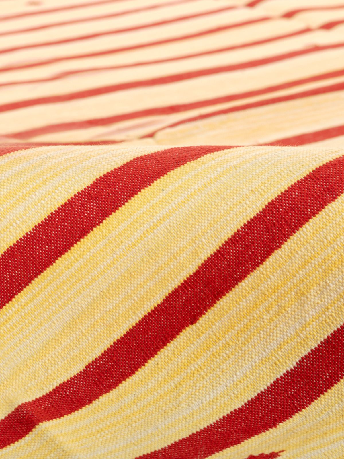 Serenity Stripes Flatweave Rug-Red detail of the striped cotton surface and edge finishing