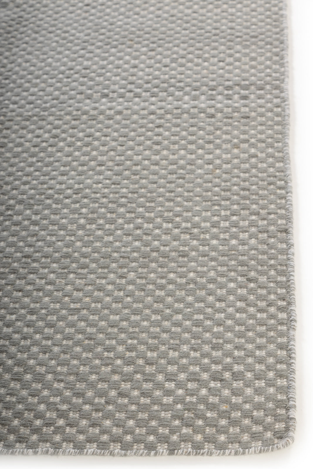 Slatefield Flatweave wool rug styled in a living room interior