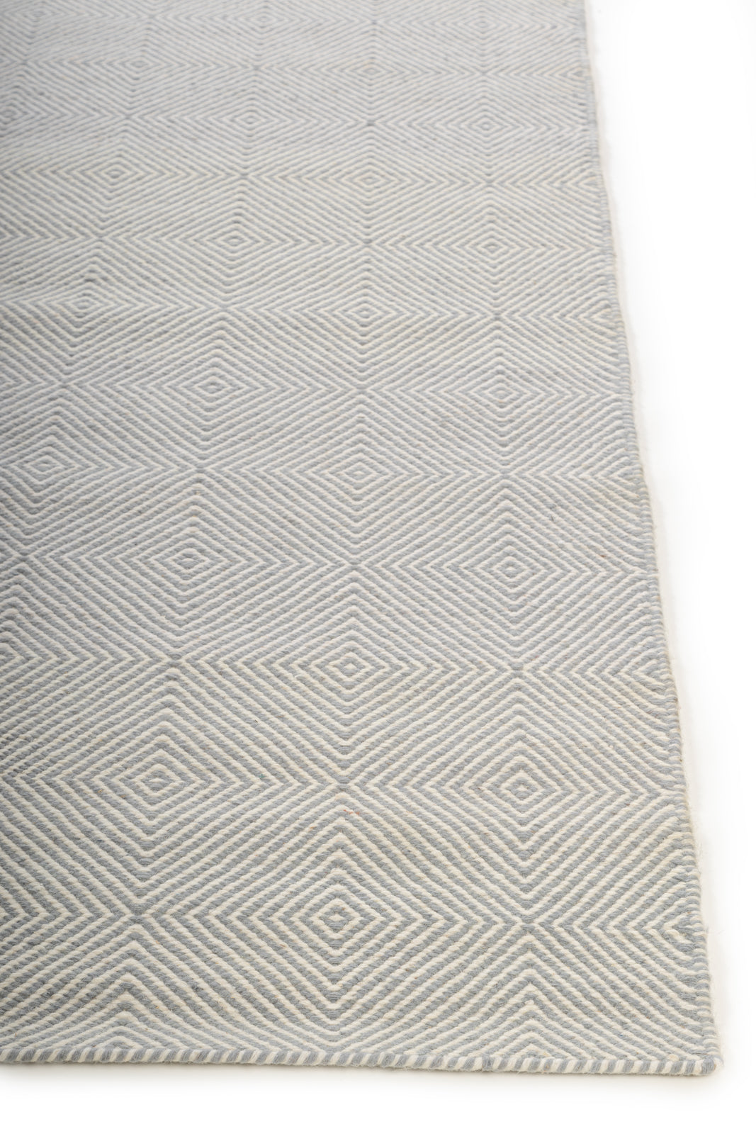Stonehaven Shuttle Rug wool rug styled in a living room interior