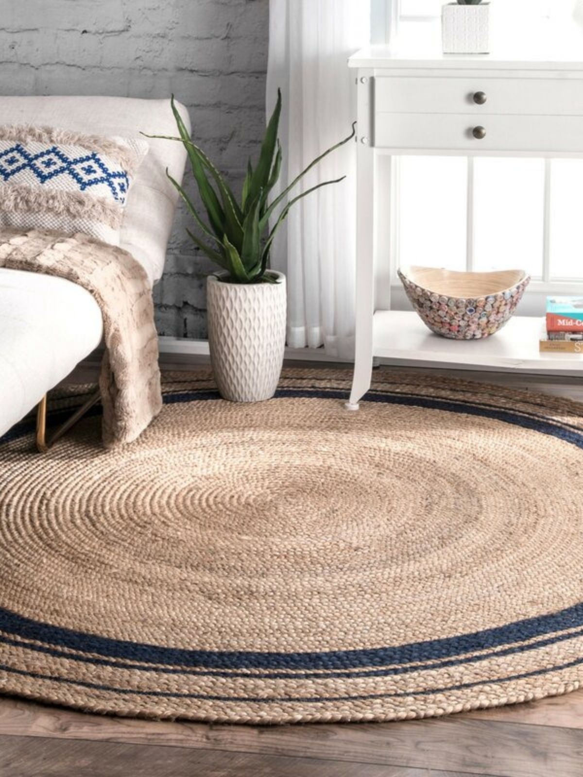 Suez bordered jute braided rug jute rug styled in a living room interior