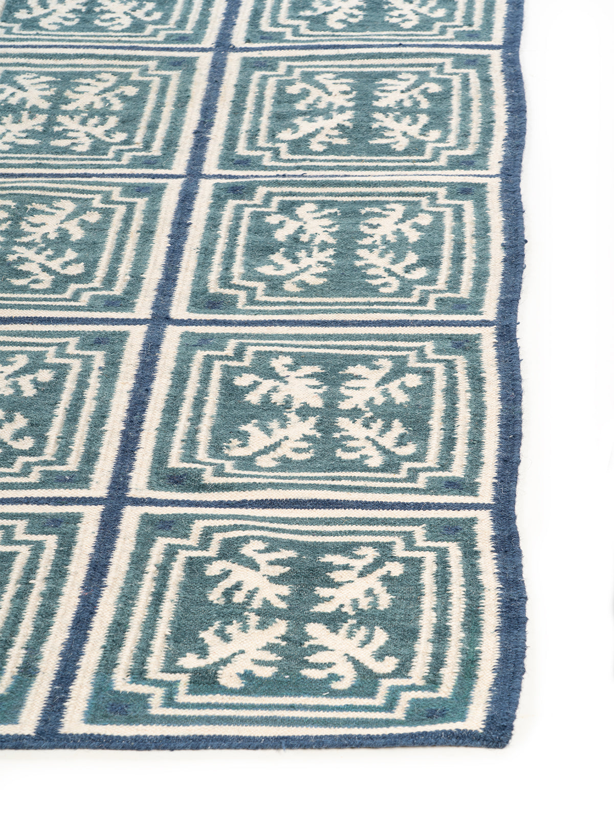 Teal & Indigo Grid Rug wool rug styled in a living room interior