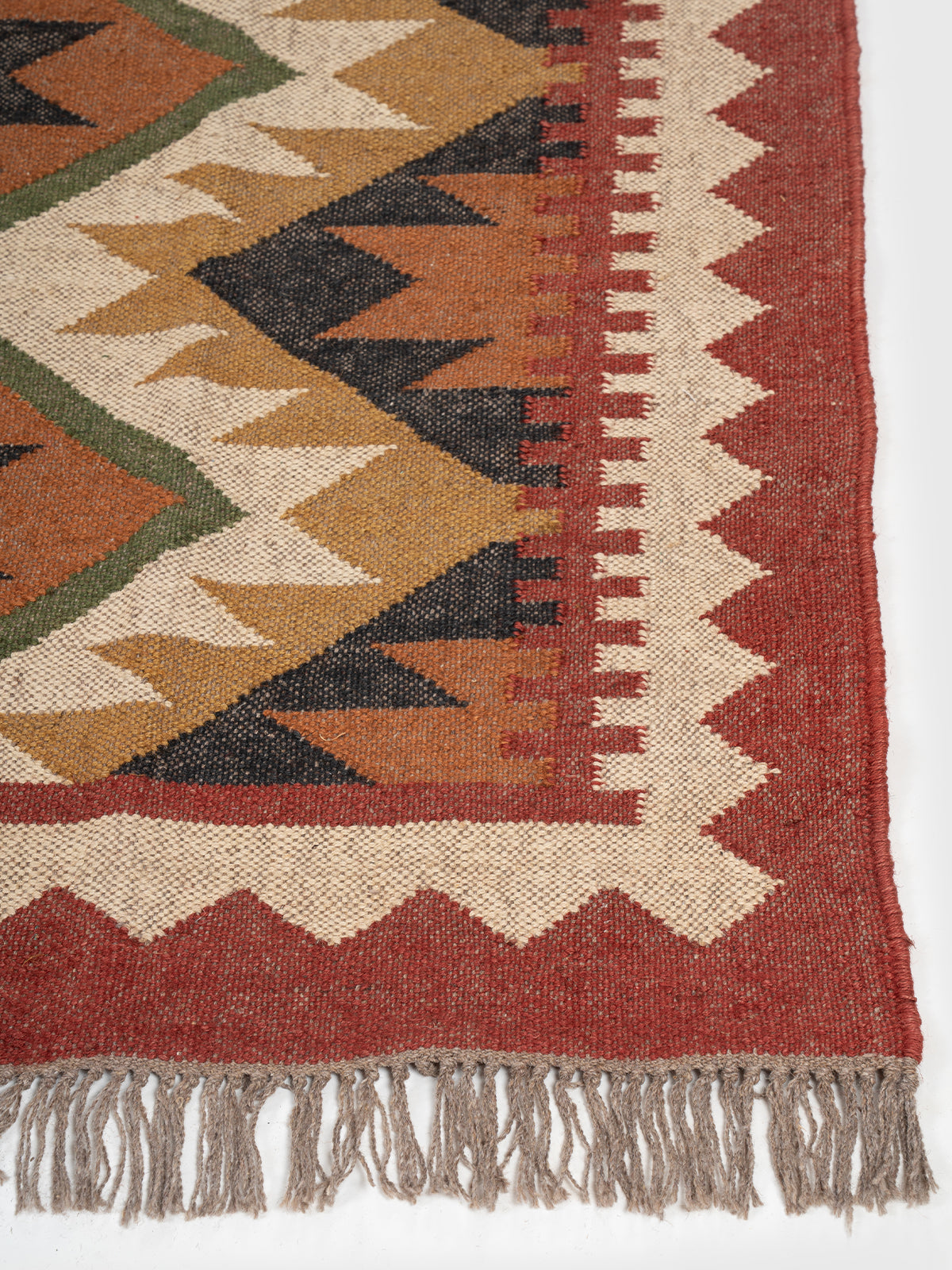 The Adobe Stack Rug wool rug styled in a living room interior