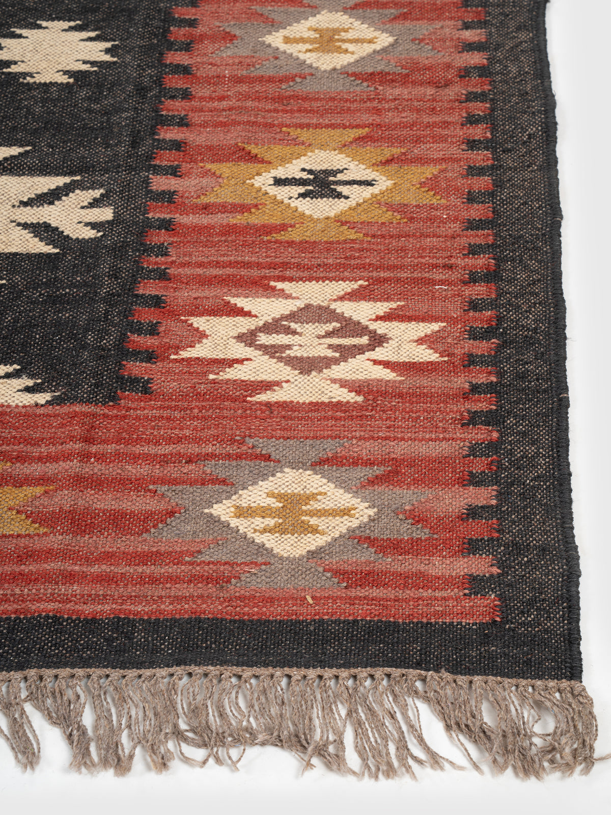 The Ancestral Column Rug wool rug styled in a living room interior