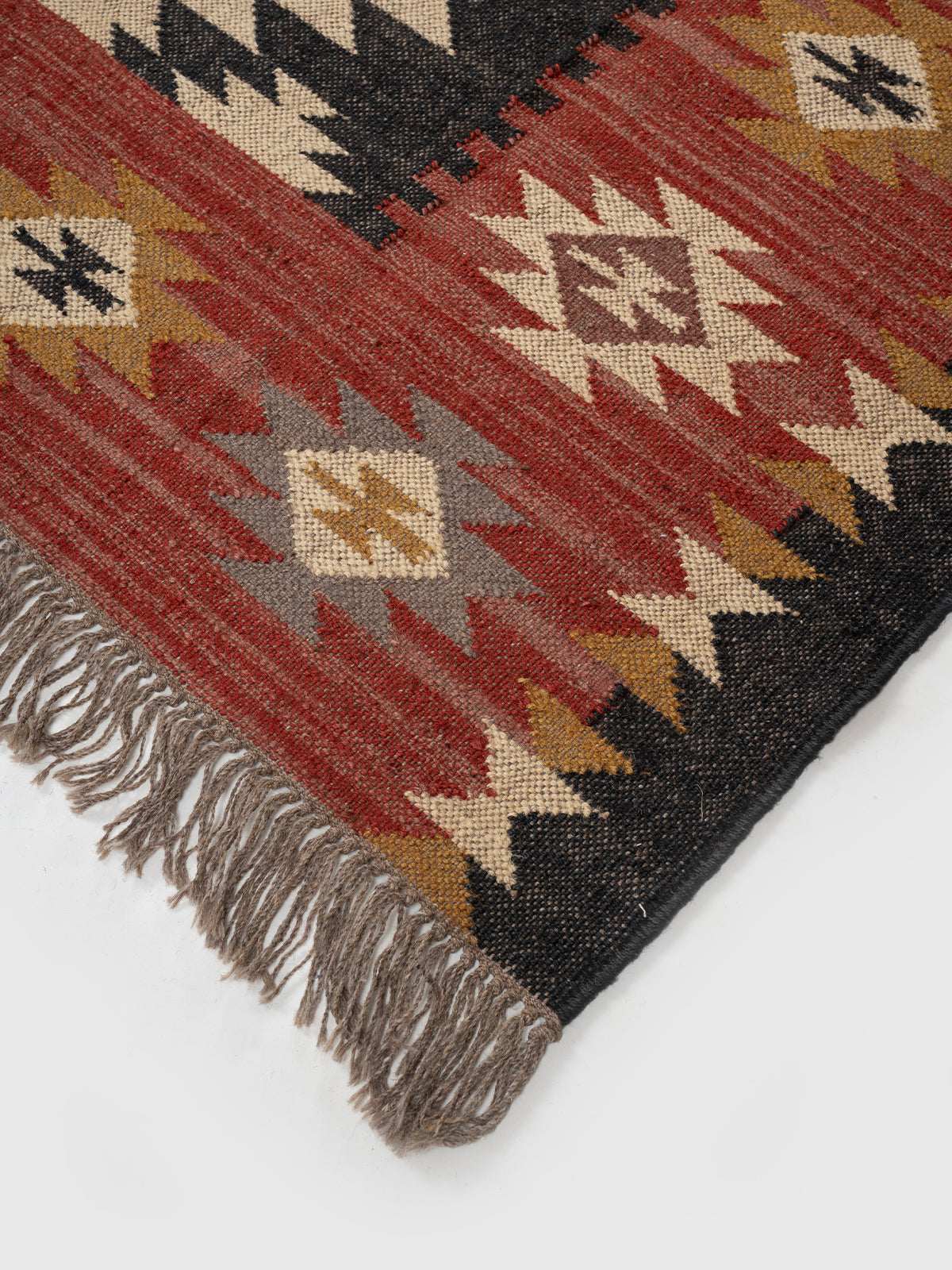 The Ancestral Glyph Rug close-up showing the wool weave and traditional motif