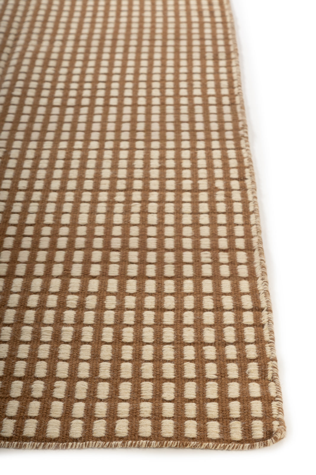 The Artisan Waffle wool rug styled in a living room interior