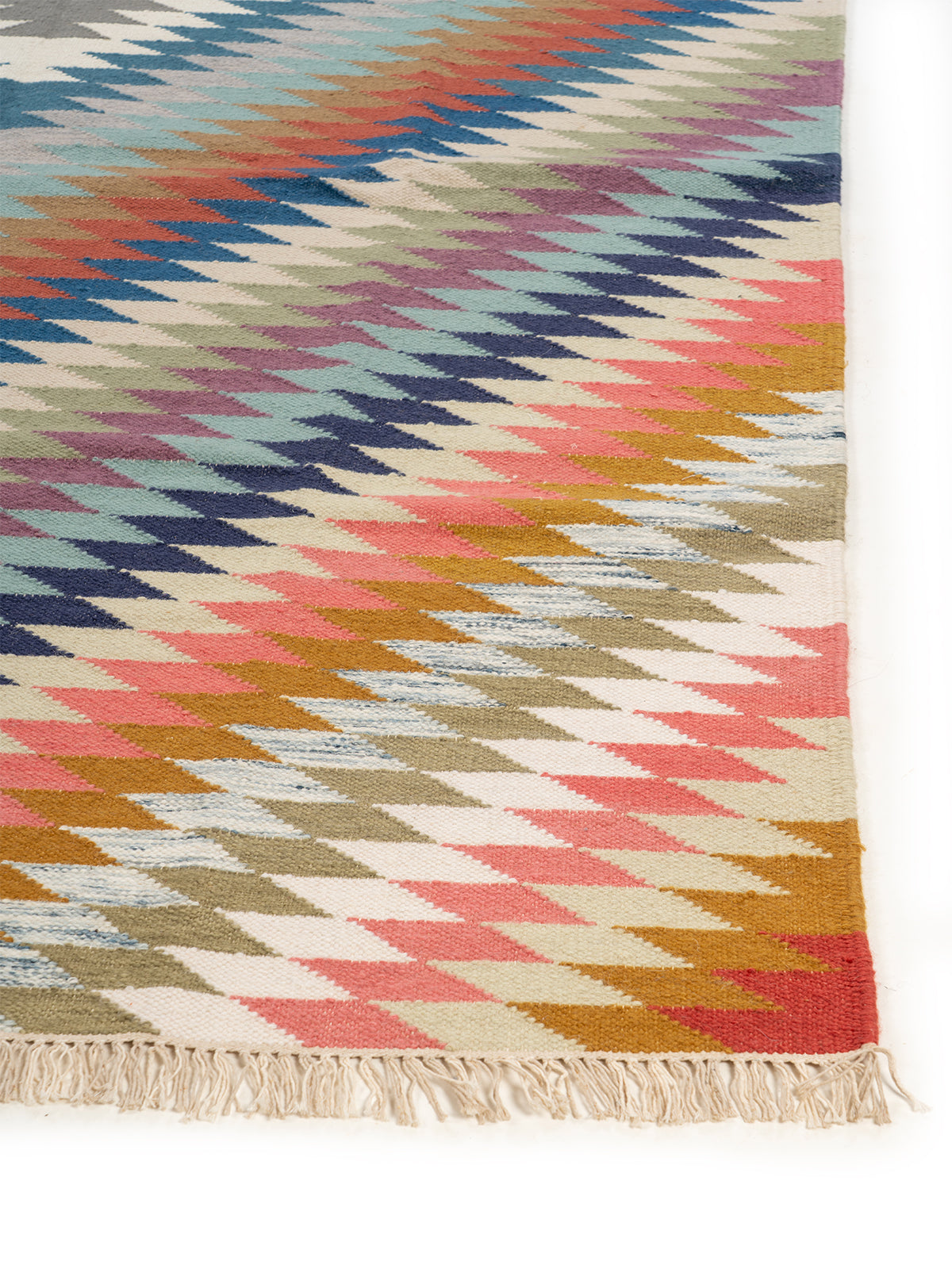 The Aurora Chevron Rug wool rug styled in a living room interior