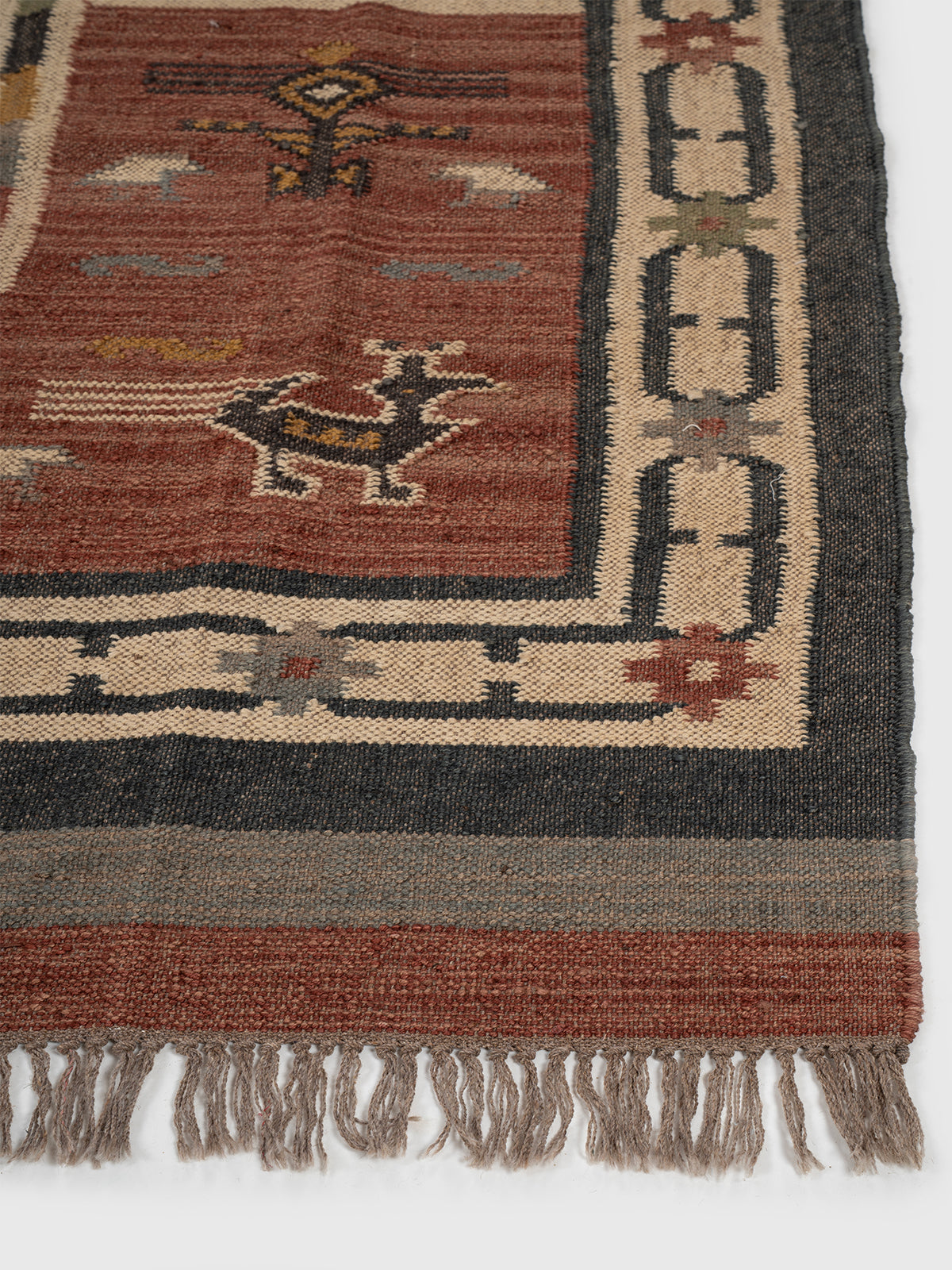 The Bestiary Weave Kilim wool rug styled in a living room interior