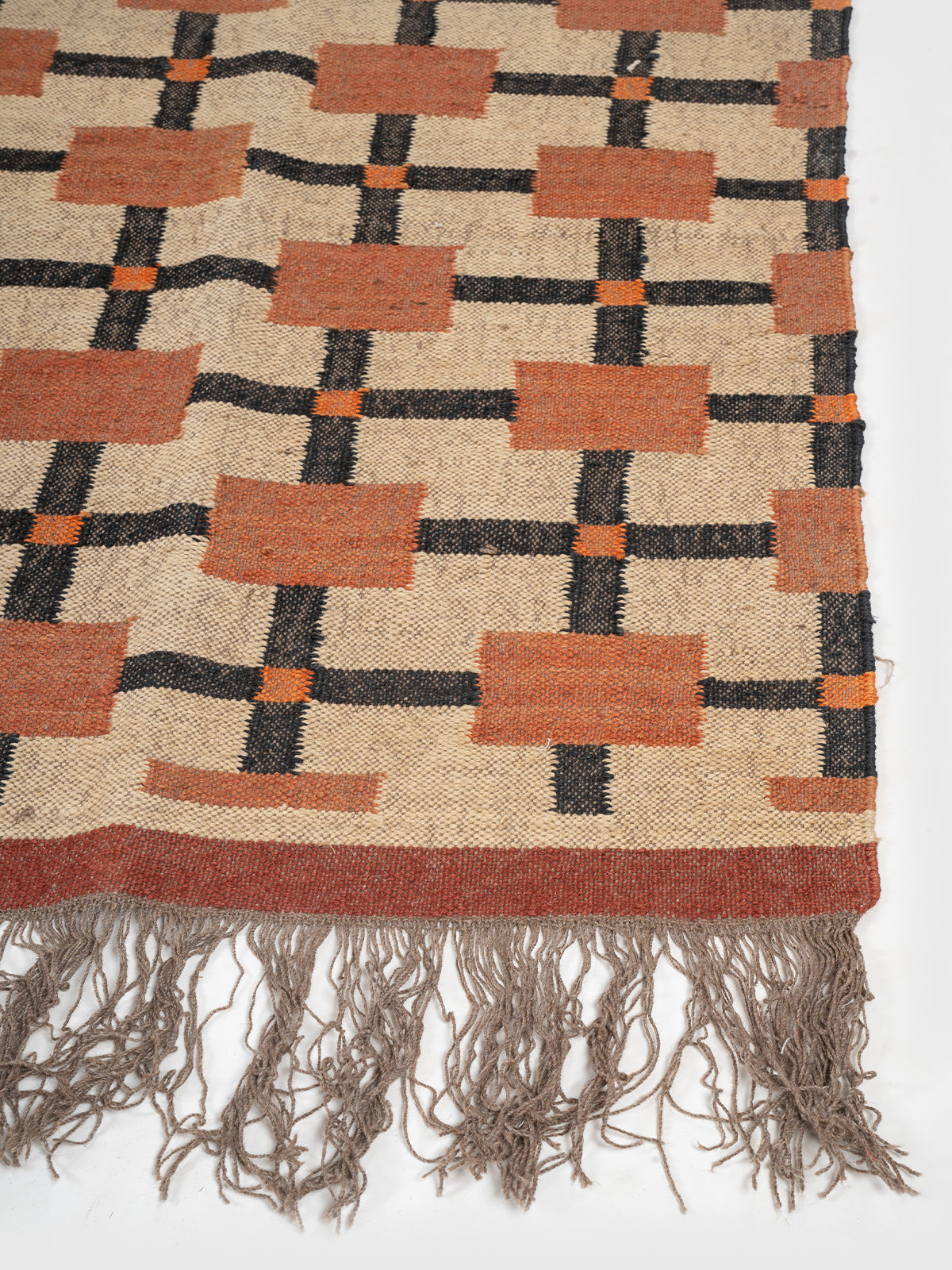 The Blush Ladder wool rug styled in a living room interior