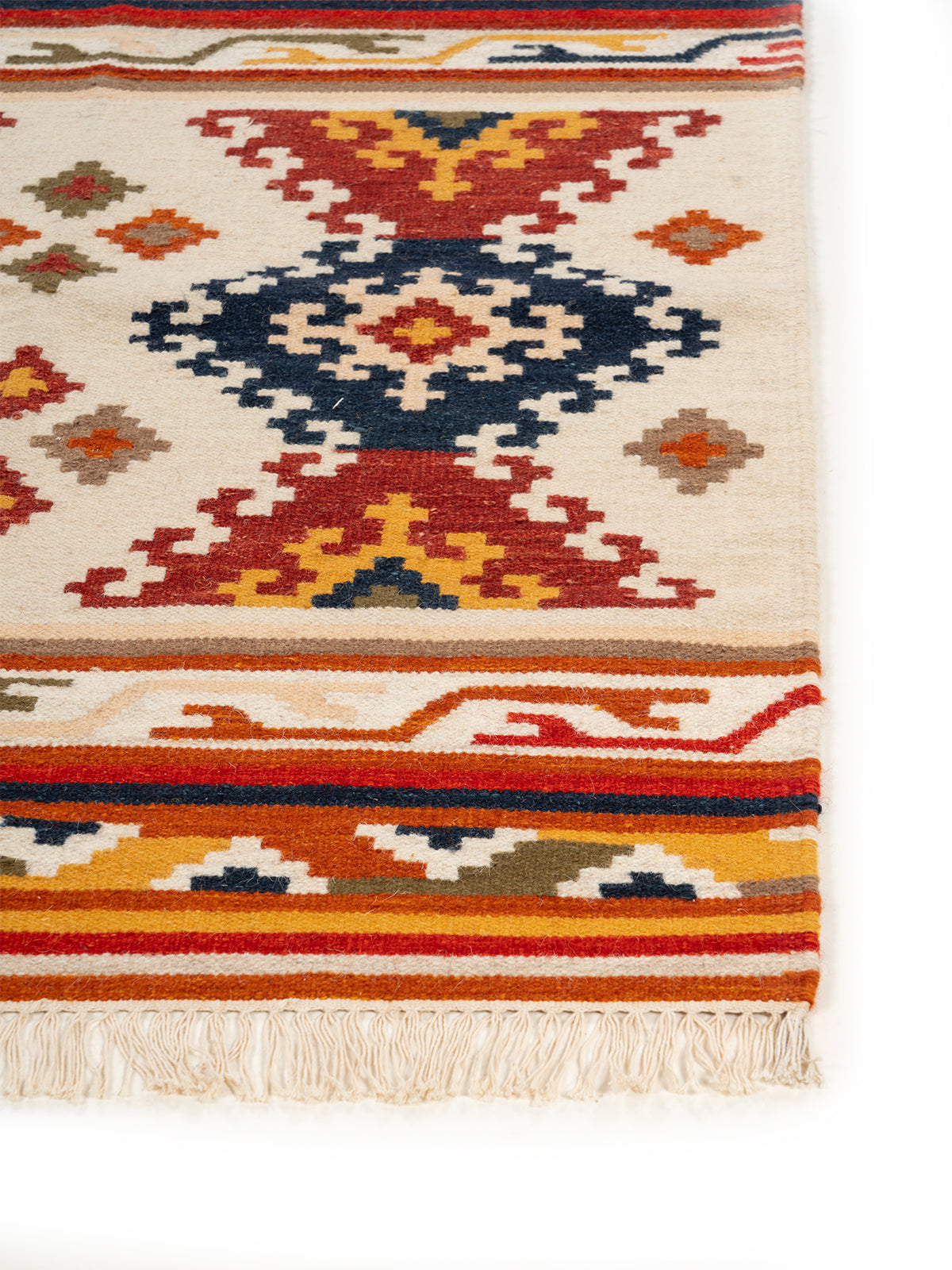 The Bohemian Diamond Rug wool rug styled in a living room interior