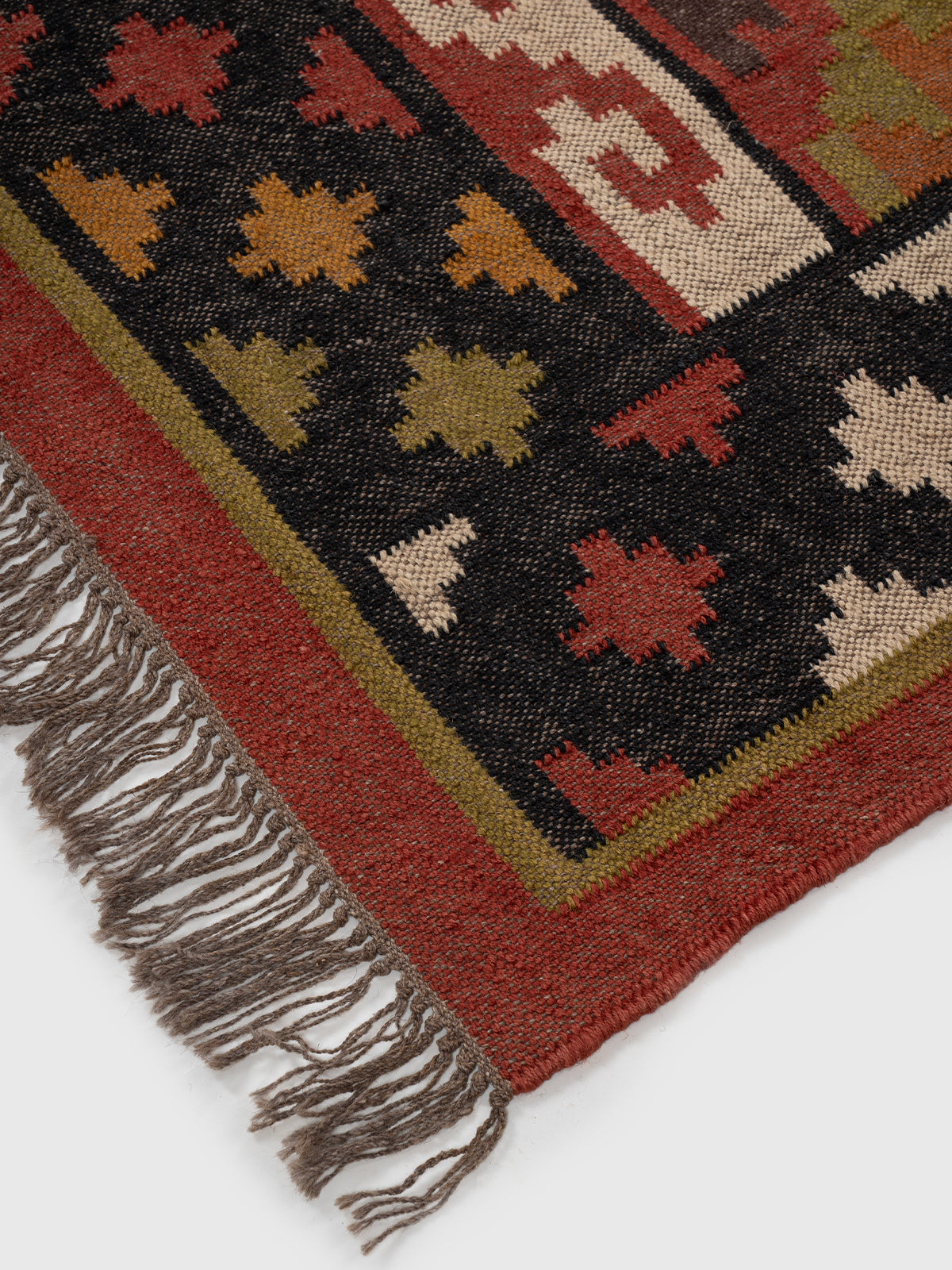 The Charcoal Medley Kilim close-up showing the wool weave and geometric motif