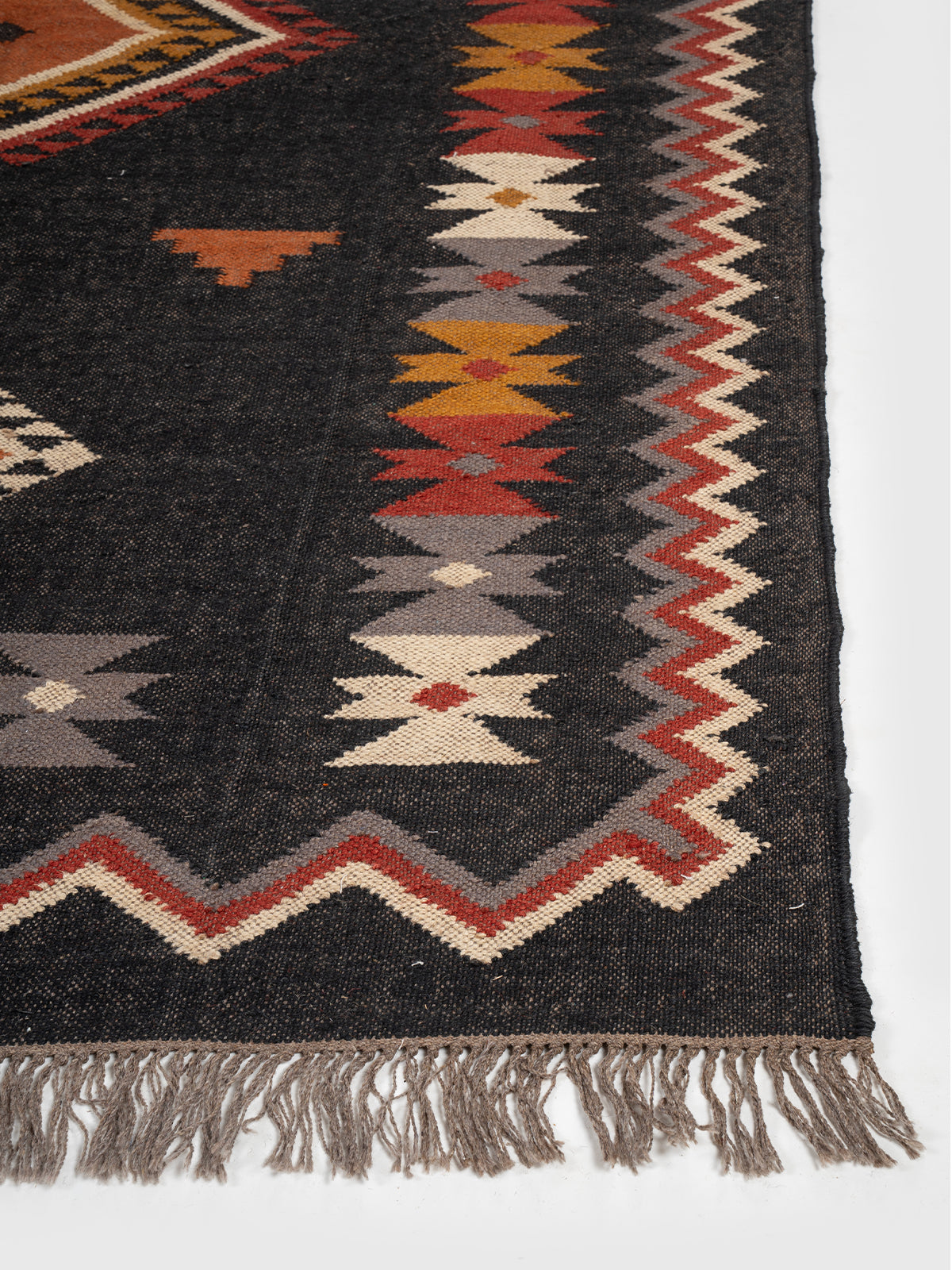 The Charcoal Peak Rug wool rug styled in a living room interior