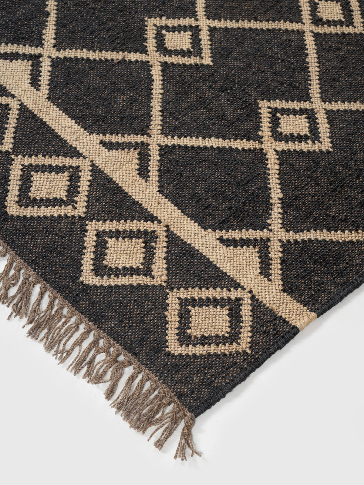 The Desert Emblem Rug close-up showing the wool weave and traditional motif