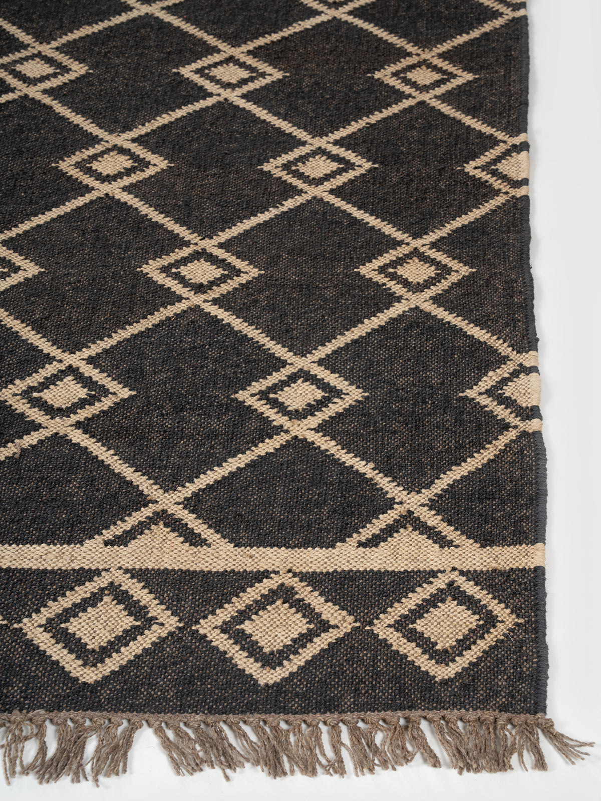 The Desert Emblem Rug wool rug styled in a living room interior