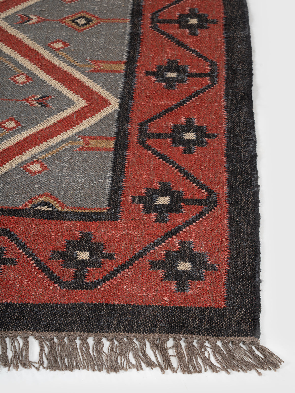 The Diamond Matrix Rug wool rug styled in a living room interior