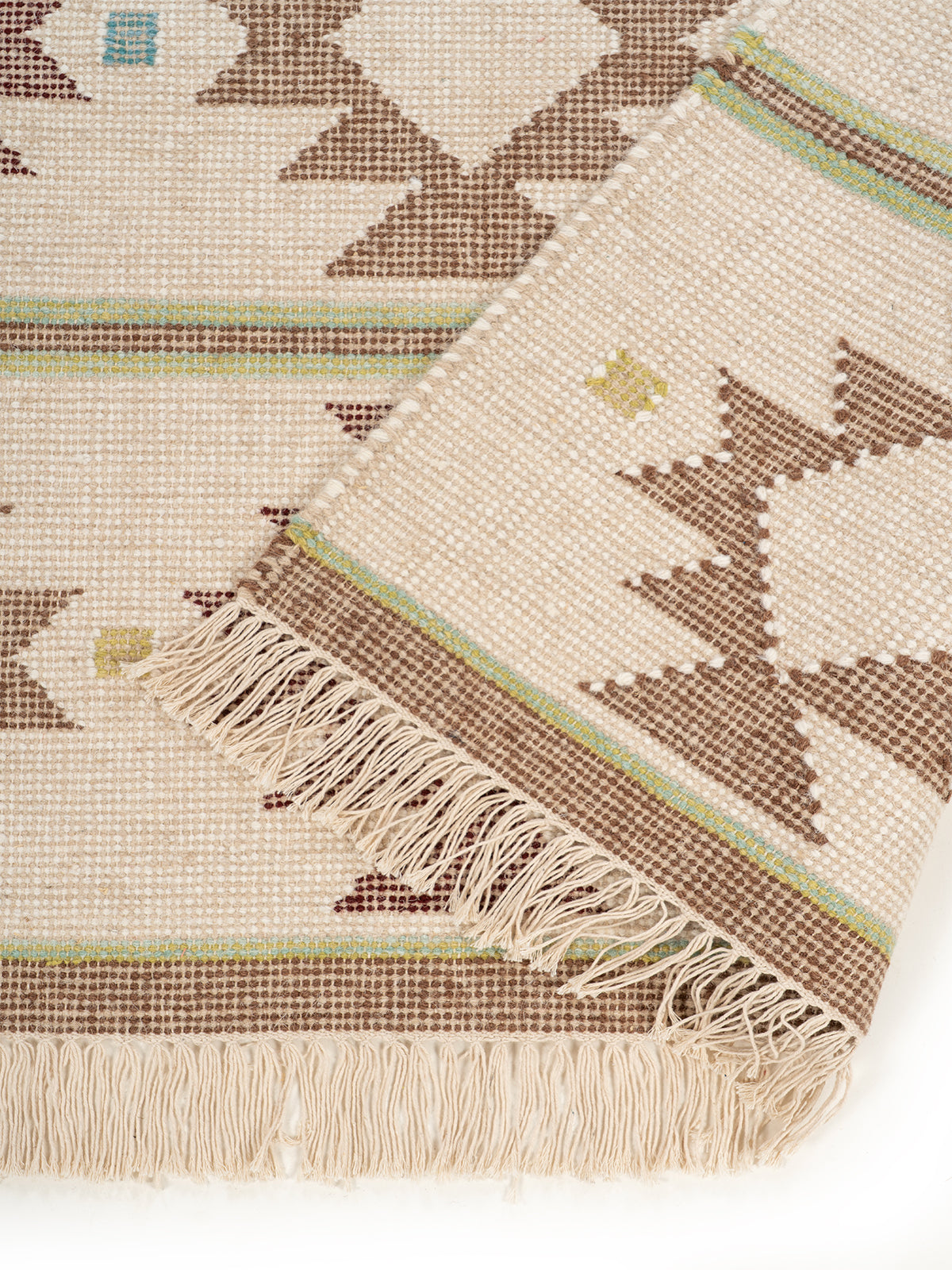 The Earth Weave Rug detail showing the textured wool surface and finishing