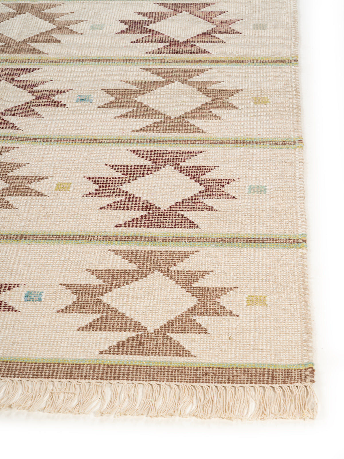 The Earth Weave Rug wool rug styled in a living room interior
