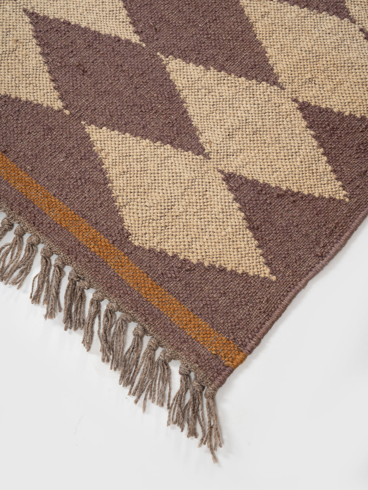 The Ember Star Rug close-up showing the wool weave and geometric motif