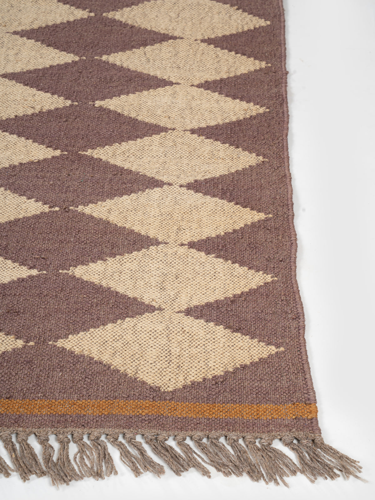 The Ember Star Rug wool rug styled in a living room interior
