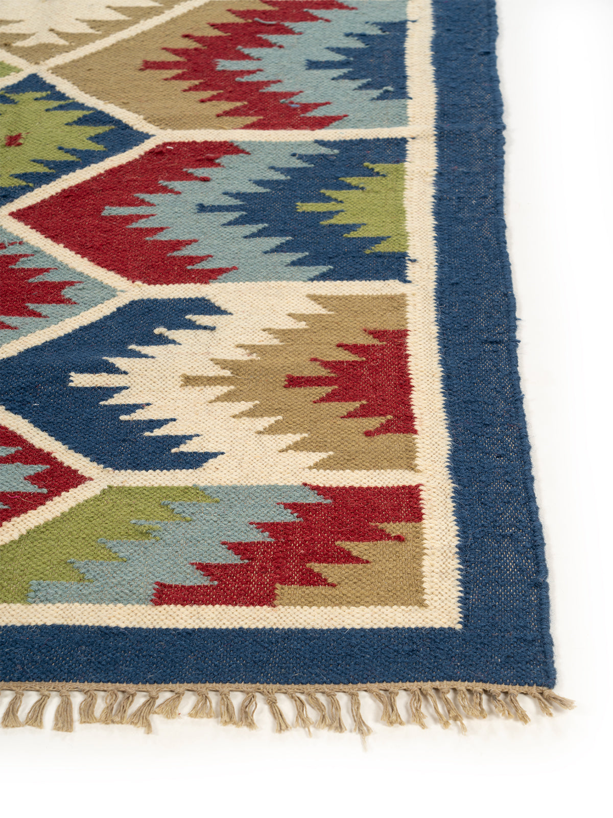The Geometric Fields Rug wool rug styled in a living room interior