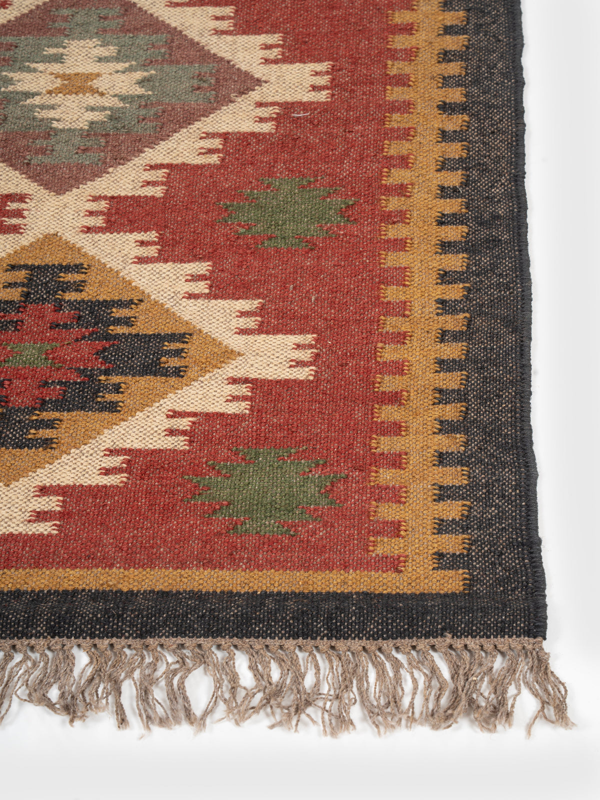 The Lunar Arrowhead wool rug styled in a living room interior