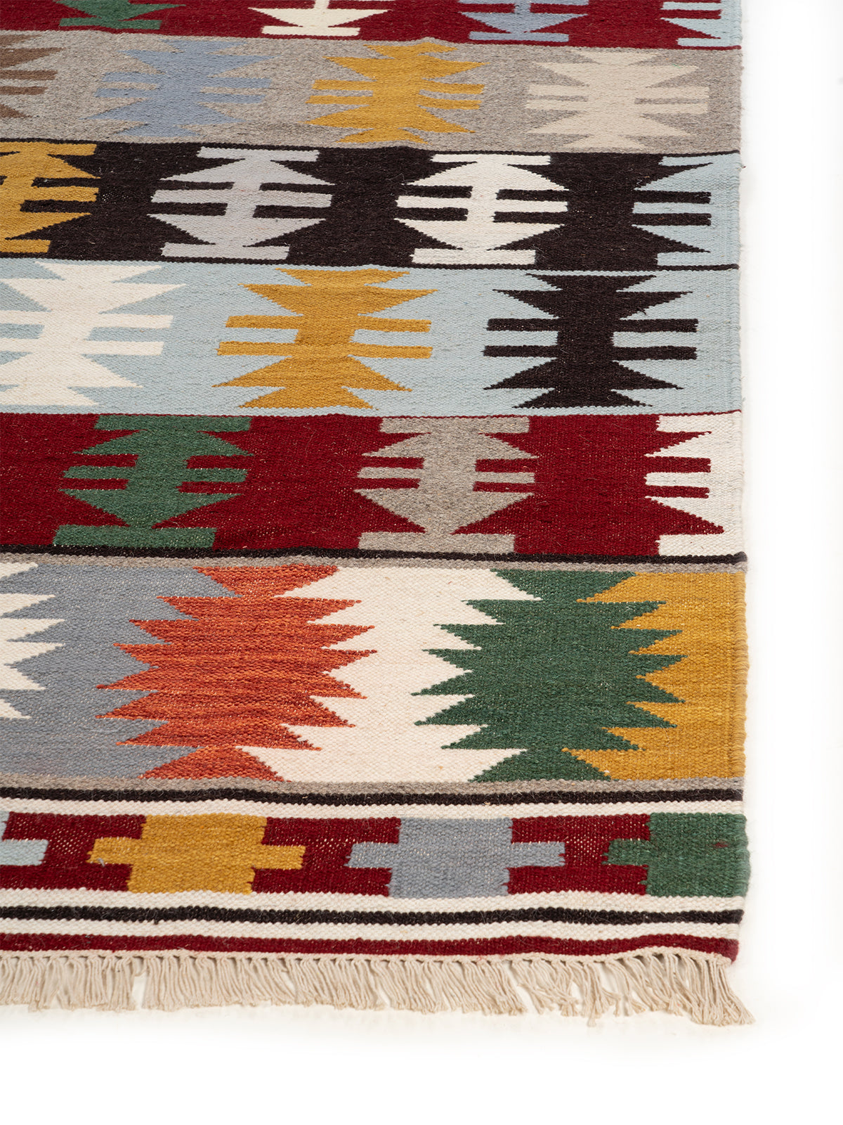 The Mountain Range Rug wool rug styled in a living room interior