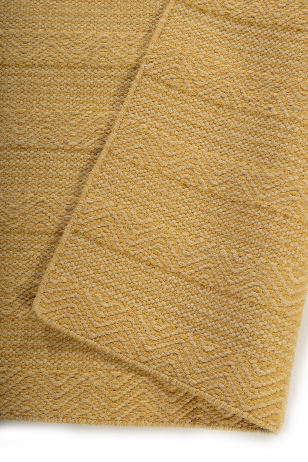 The Ochre Herringbone detail of the striped wool surface and edge finishing