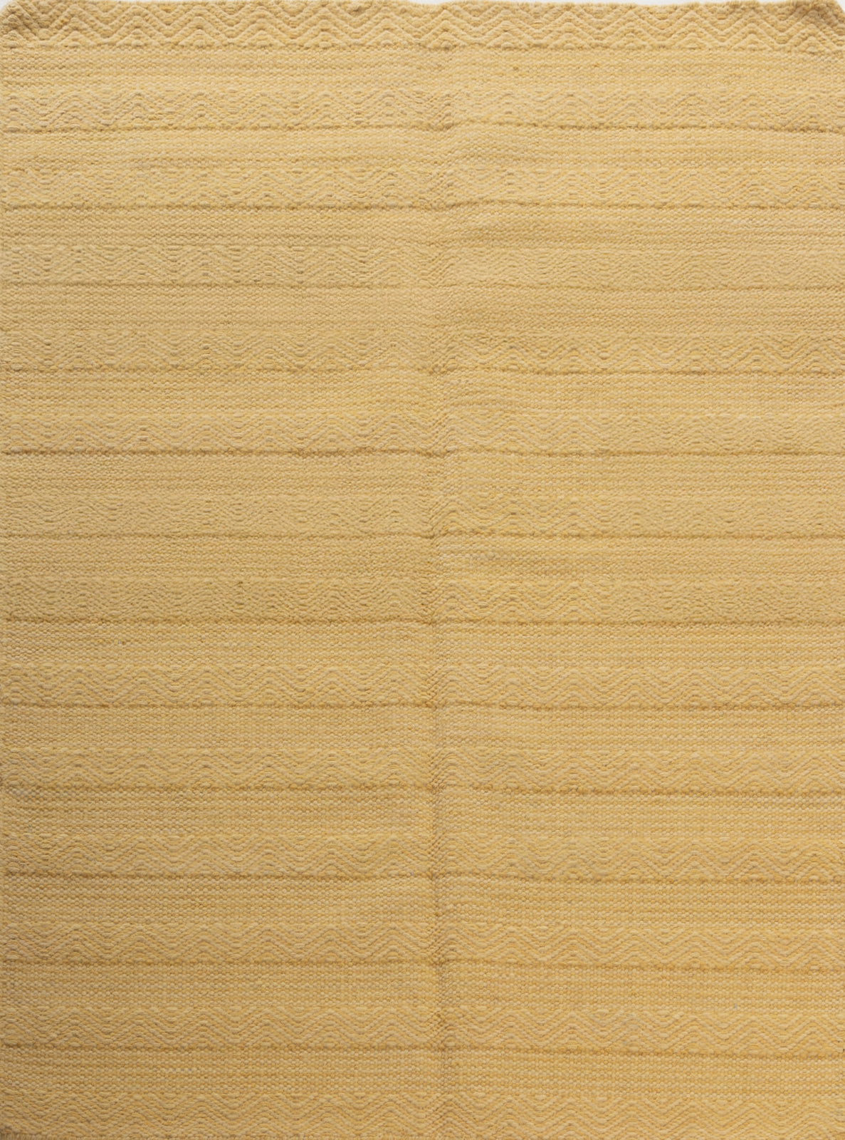 The Ochre Herringbone wool rug in yellow tones