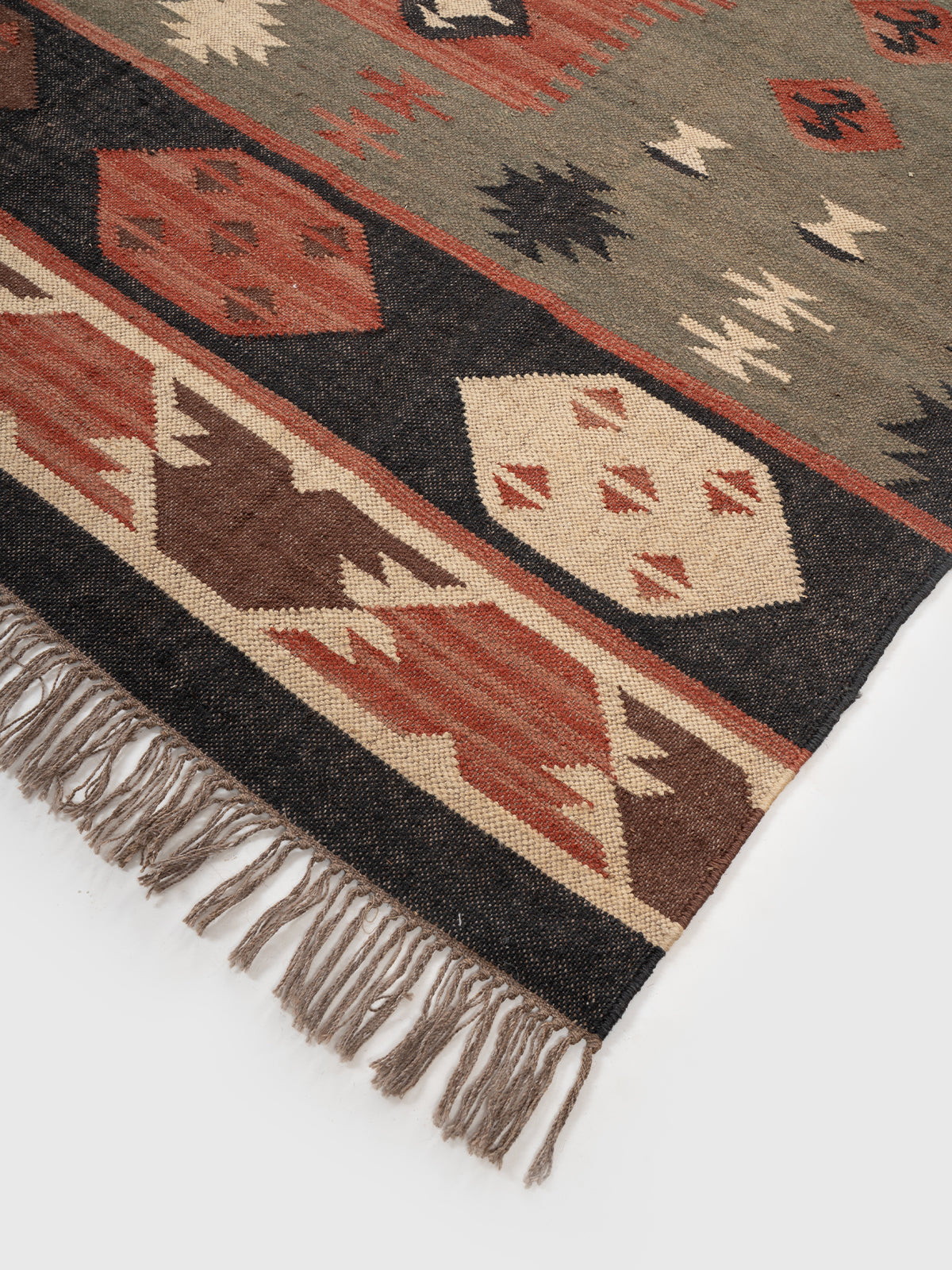 The Olive Talisman Rug close-up showing the wool weave and traditional motif