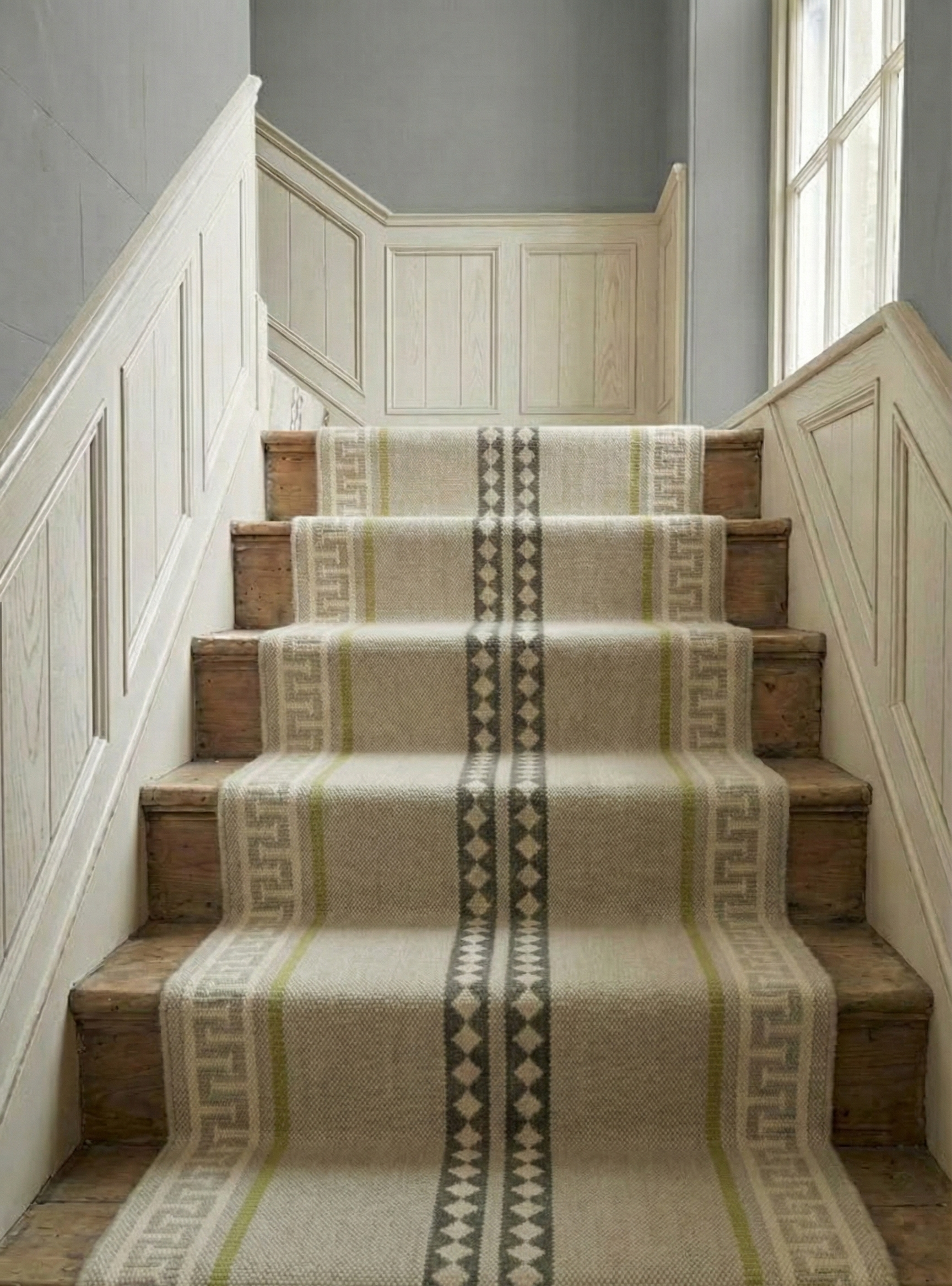 The Palace Key Runner-Green cotton stair runner styled on a staircase in a designed interior