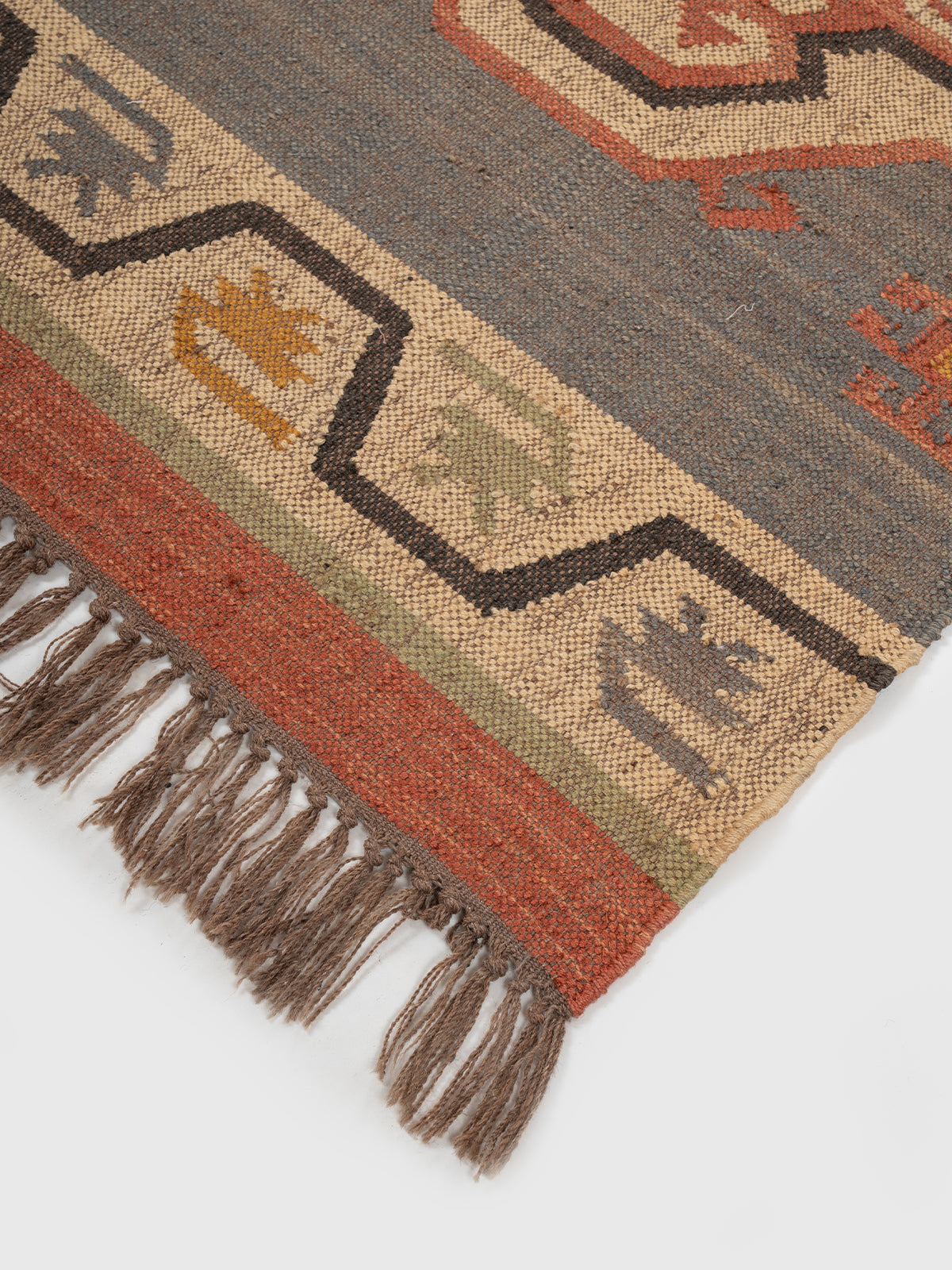 The Patterned Shield Runner close-up showing the wool weave and geometric surface