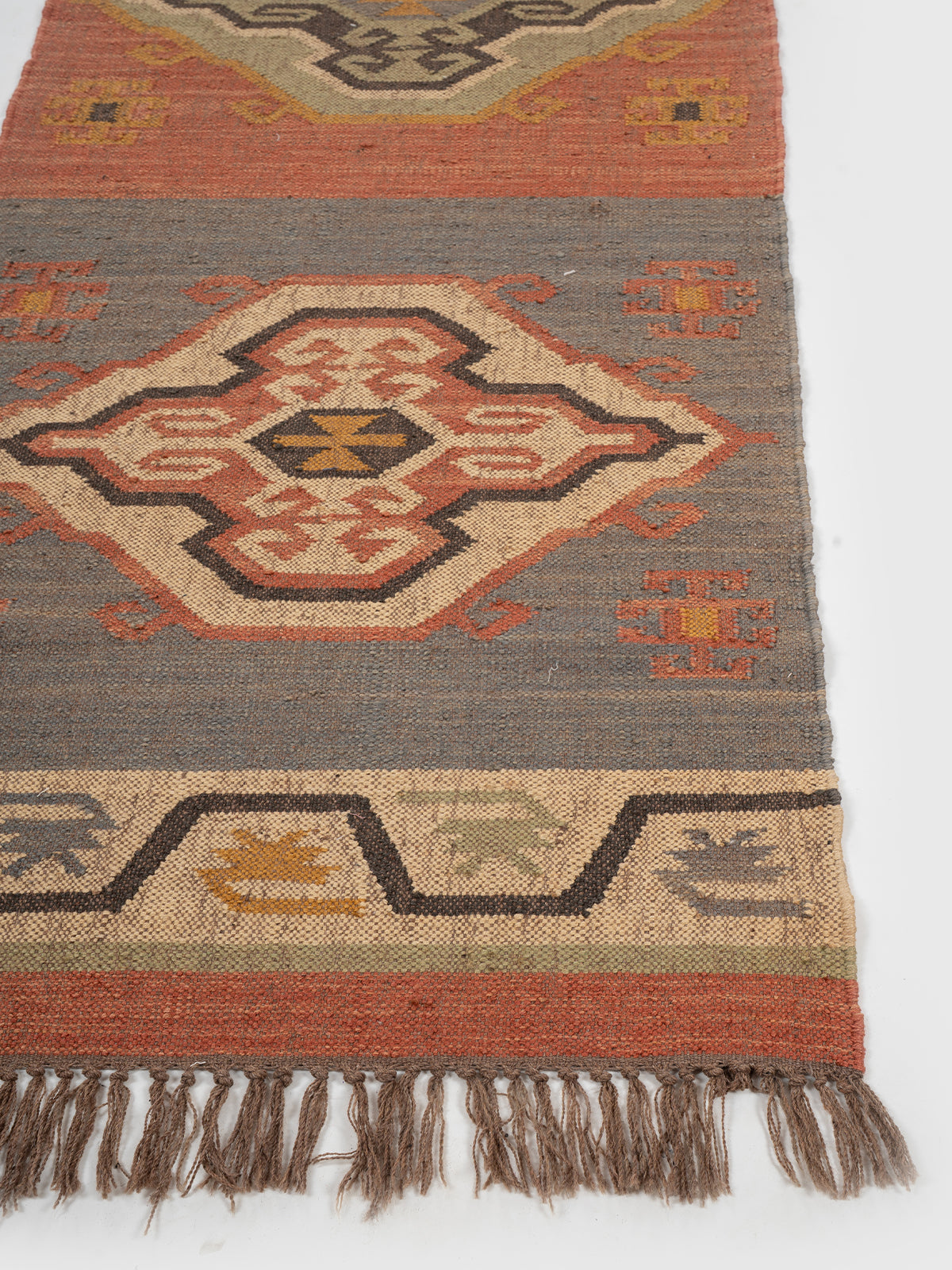 The Patterned Shield Runner wool stair runner styled on a staircase in a designed interior